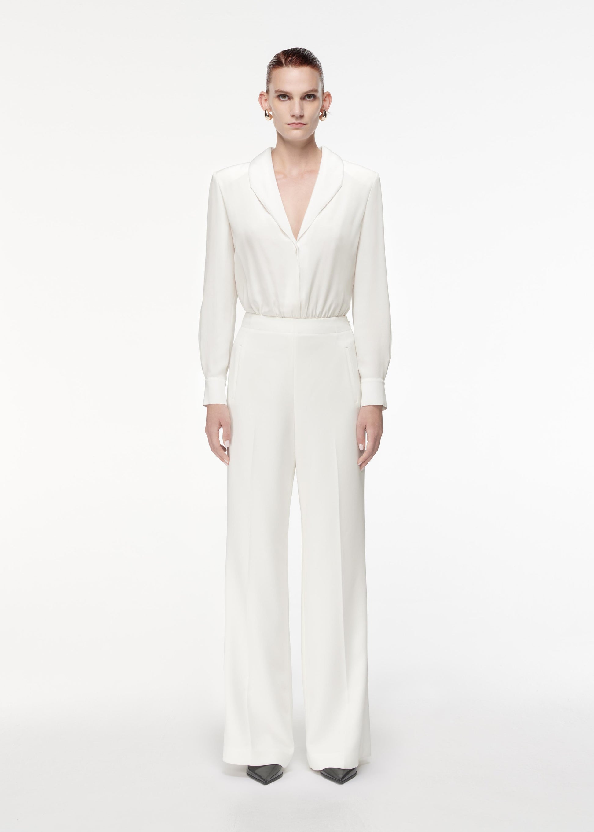 Front view of a model wearing the High Waisted Wide Leg Trouser in White