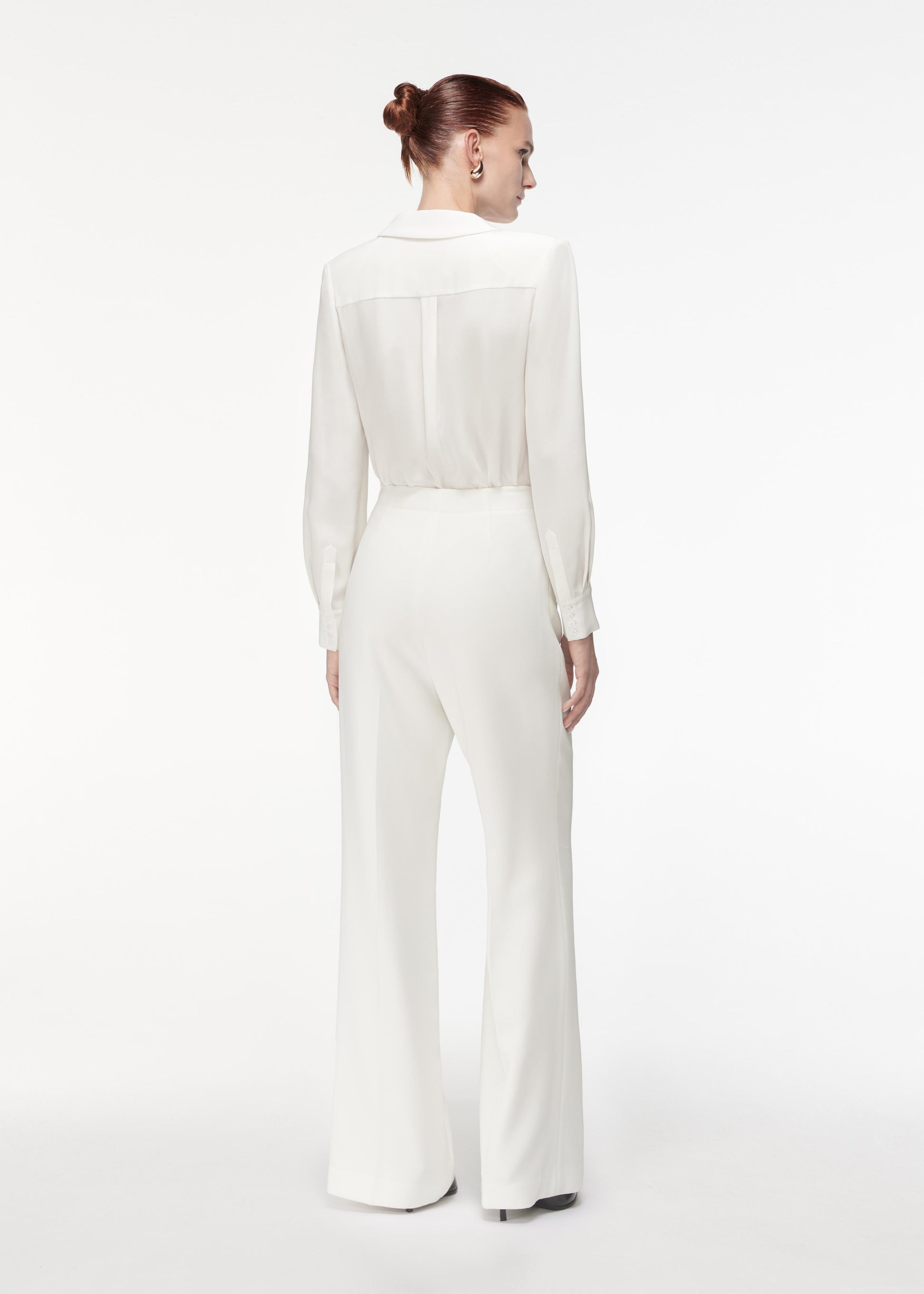 Back view of a model wearing the High Waisted Wide Leg Trouser in White