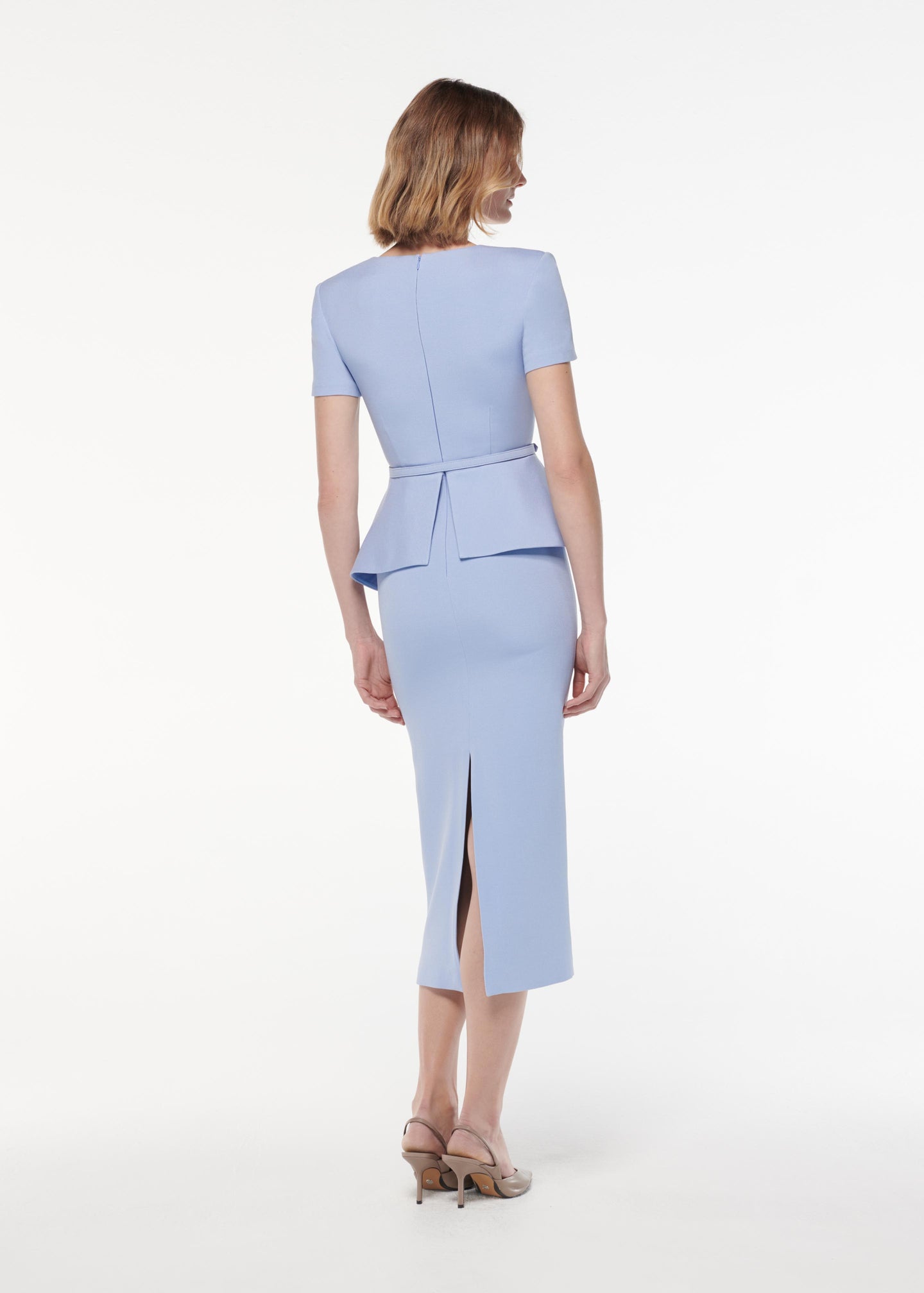 A photograph of a woman wearing a Short Sleeve Stretch Wool Silk Midi Dress in Blue