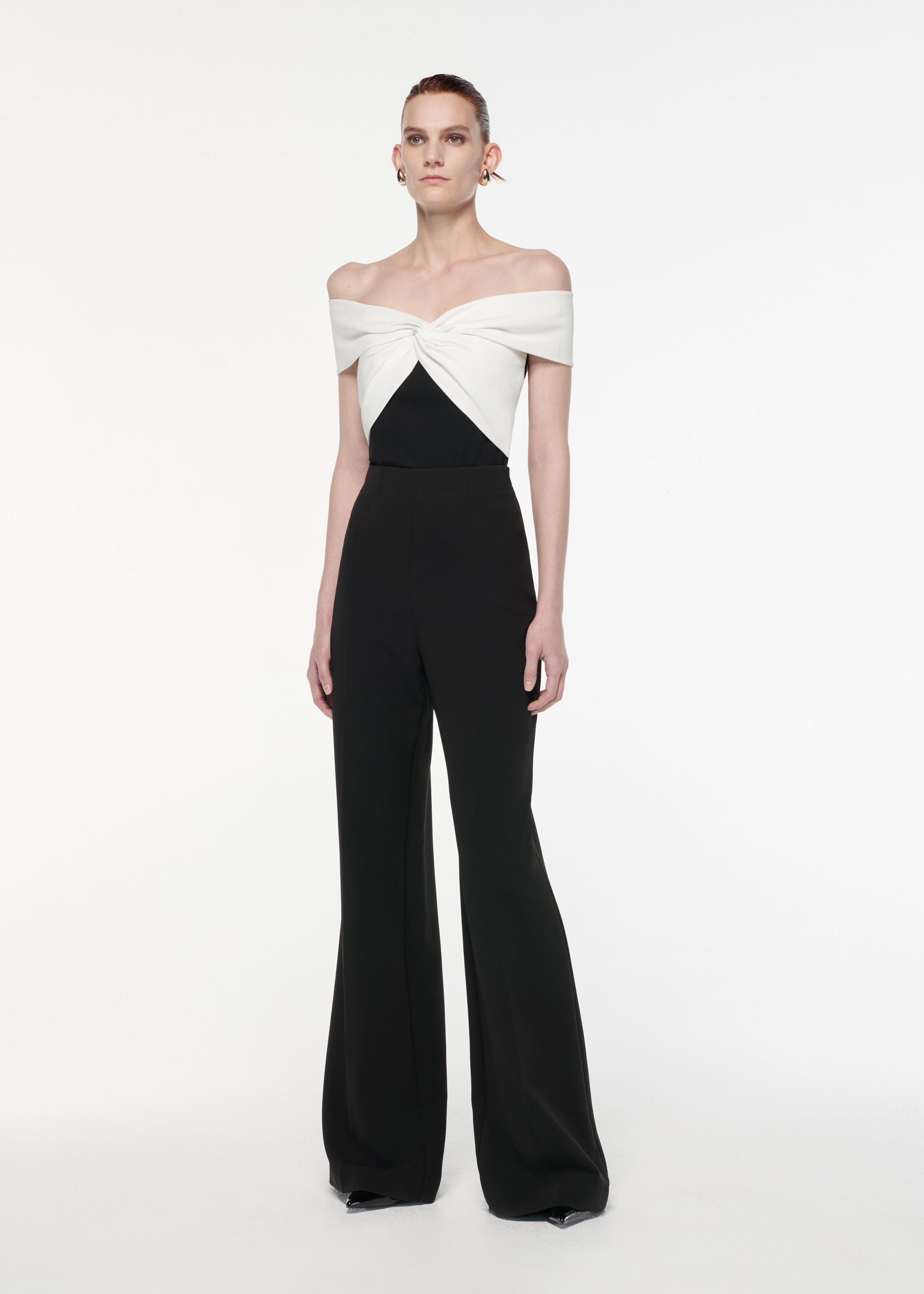 A photograph of a woman wearing a Off The Shoulder Light Cady Top in Monochrome