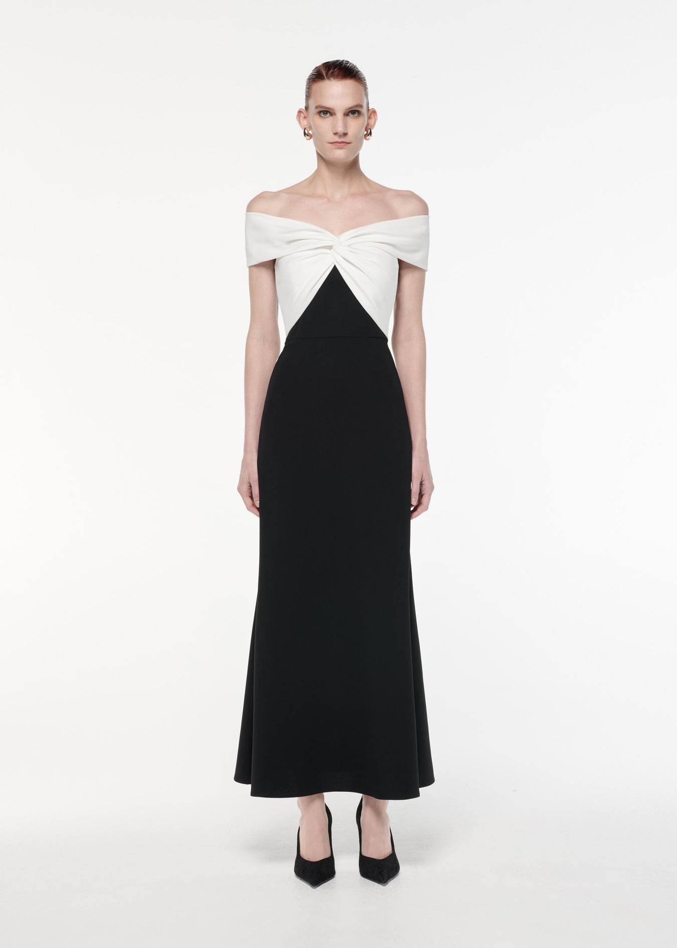 A photograph of a woman wearing a Off The Shoulder Light Cady Maxi Dress in Monochrome