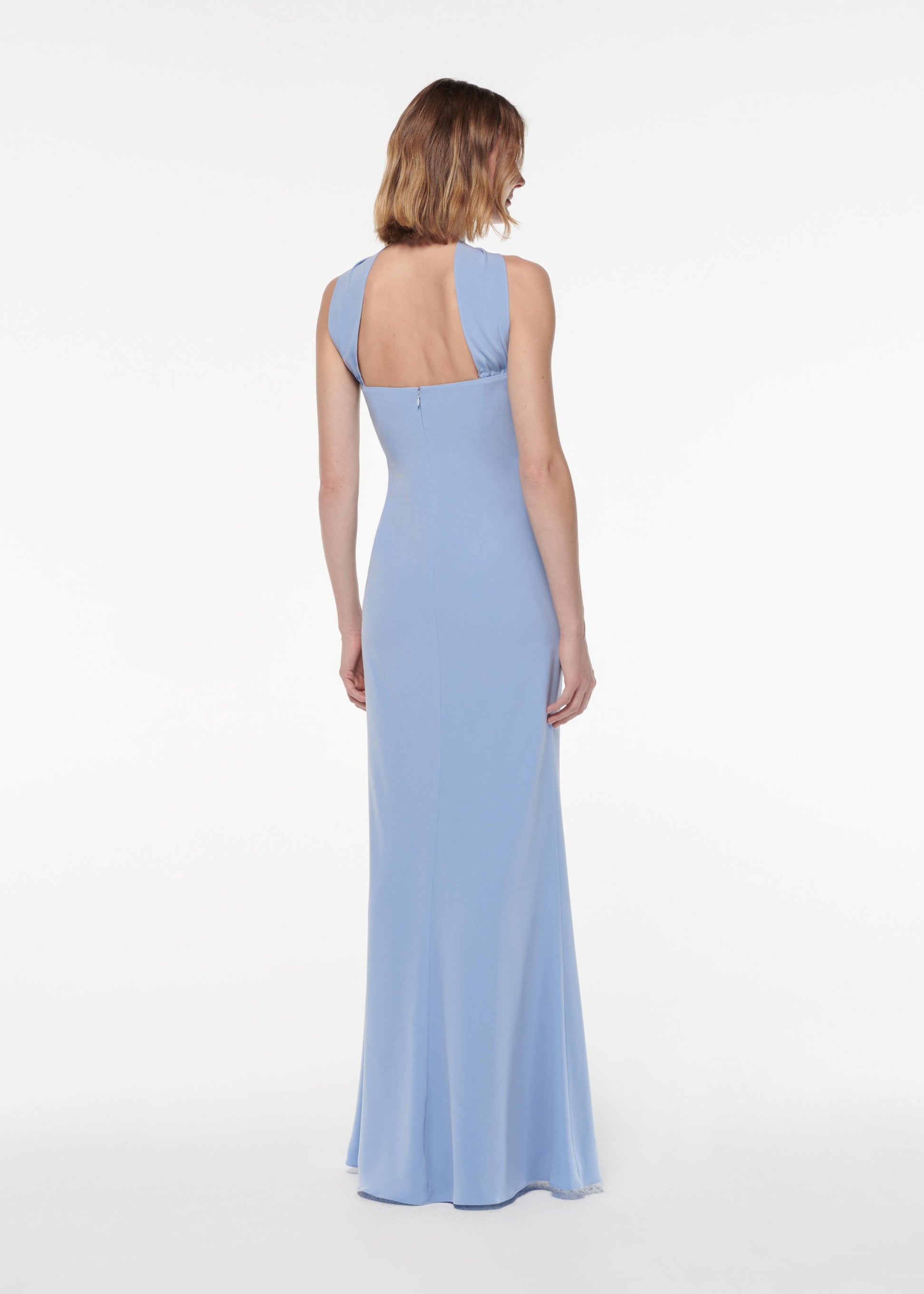 A photograph of a woman wearing a Sash Satin Crepe Gown in Blue