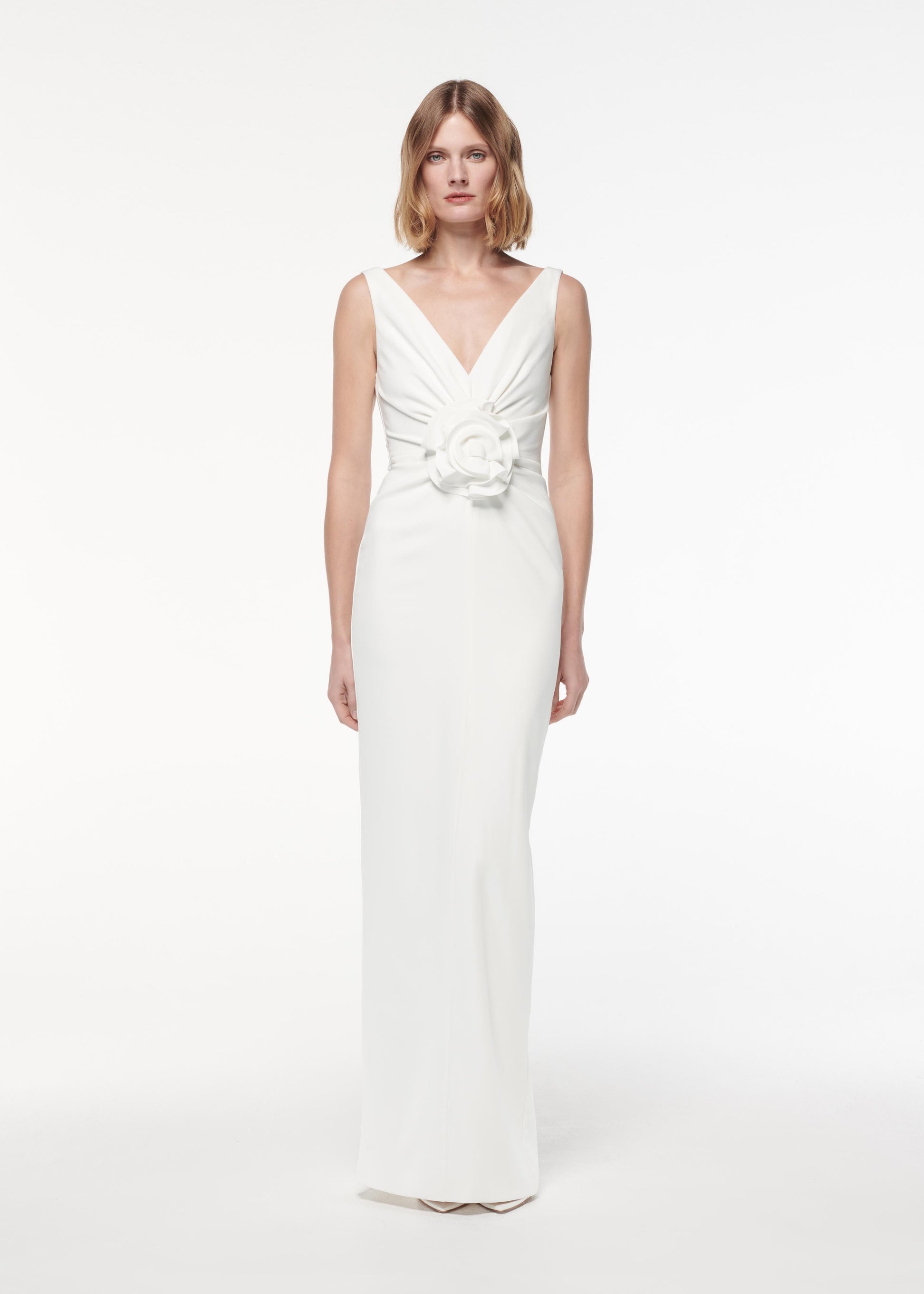 A photograph of a woman wearing a Flower Detail Gown in White