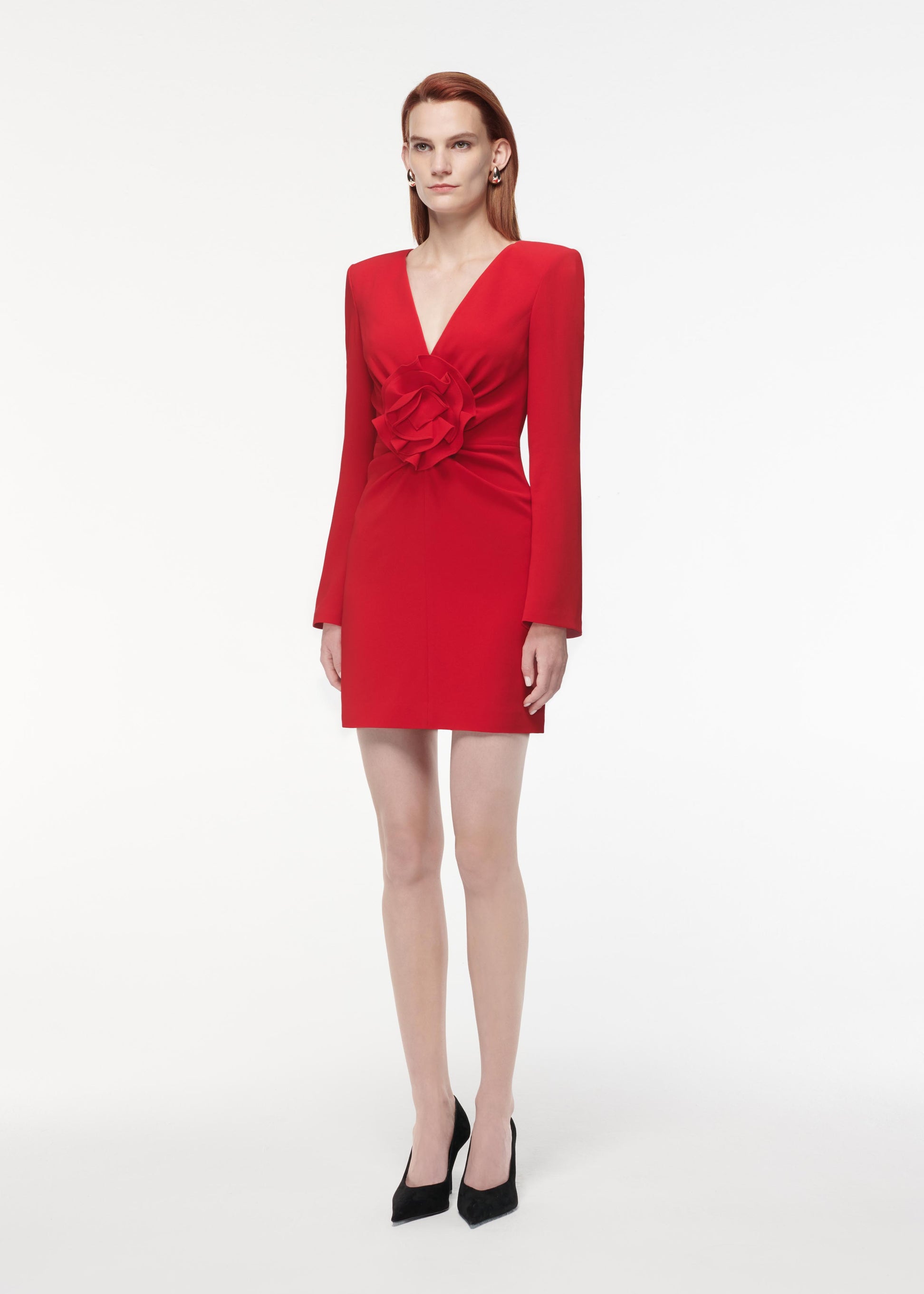 A photograph of a woman wearing a Long Sleeve Flower Detail Mini Dress in Red