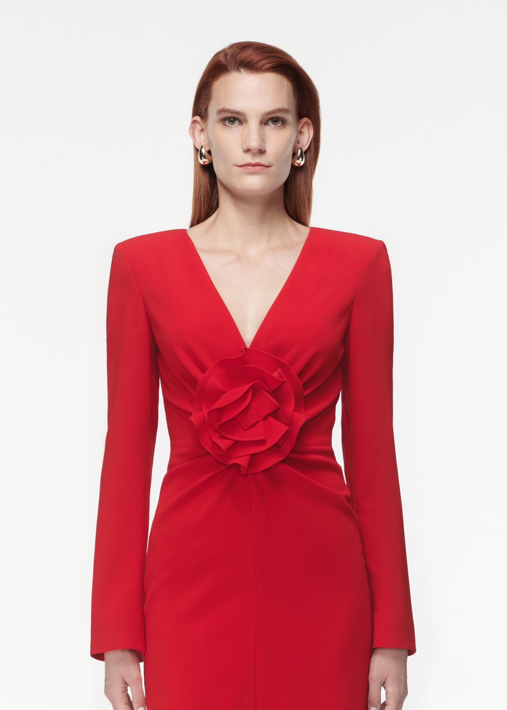 A photograph of a woman wearing a Long Sleeve Flower Detail Mini Dress in Red