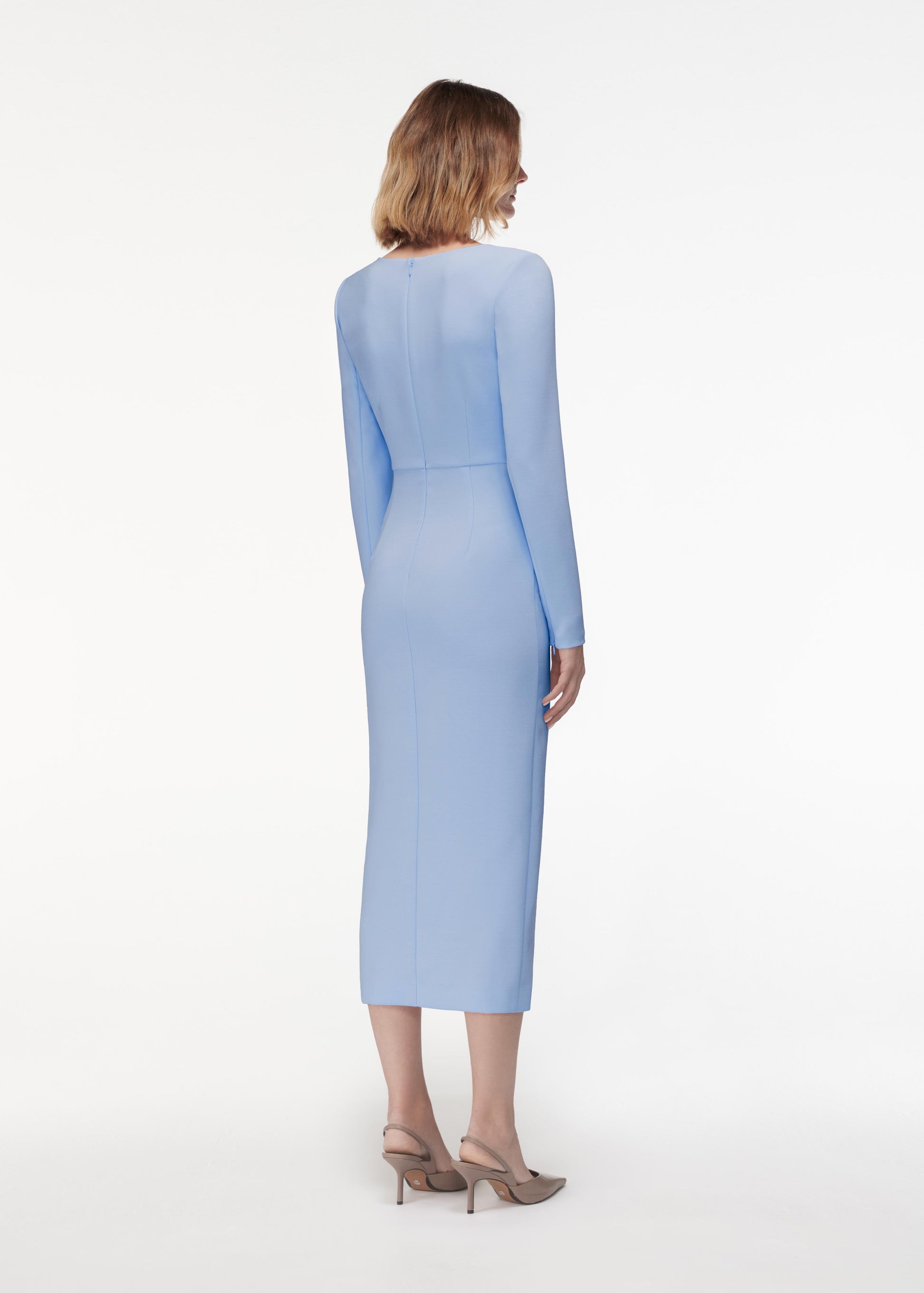 A photograph of a woman wearing a Long Sleeve Crepe Midi Dress Light in Blue