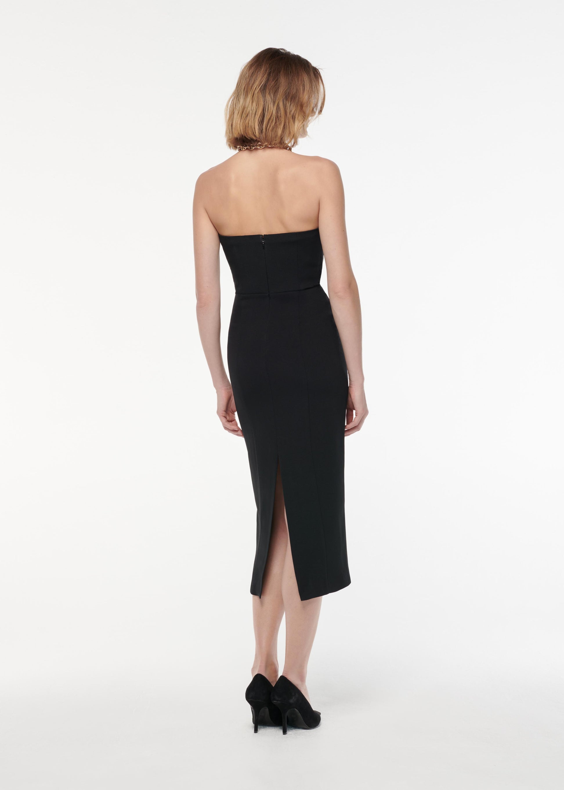 A photograph of a woman wearing a Strapless Stretch Wool Silk Midi Dress in Black