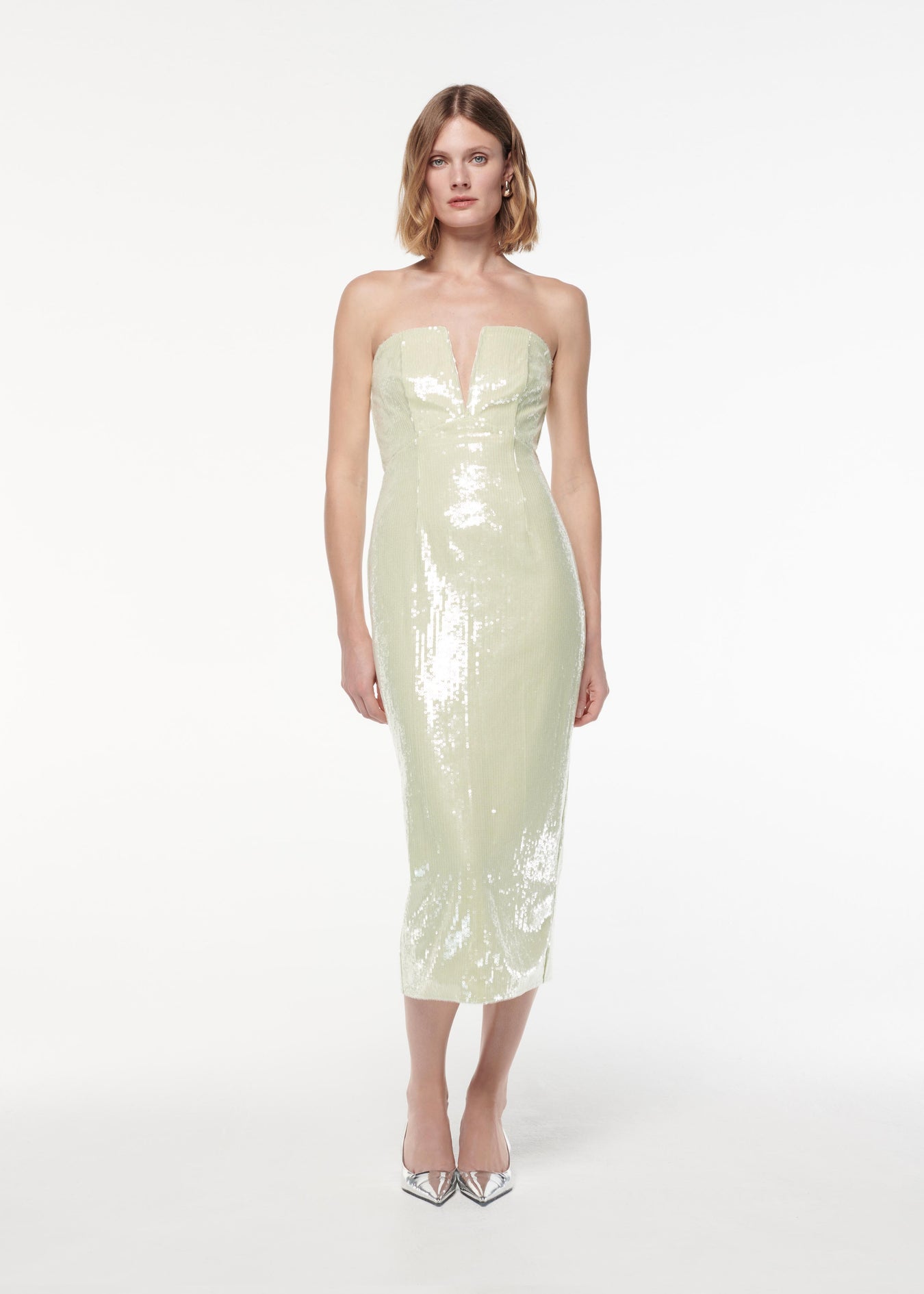 A photograph of a woman wearing a Strapless V Neck Sequin Midi Dress in Green