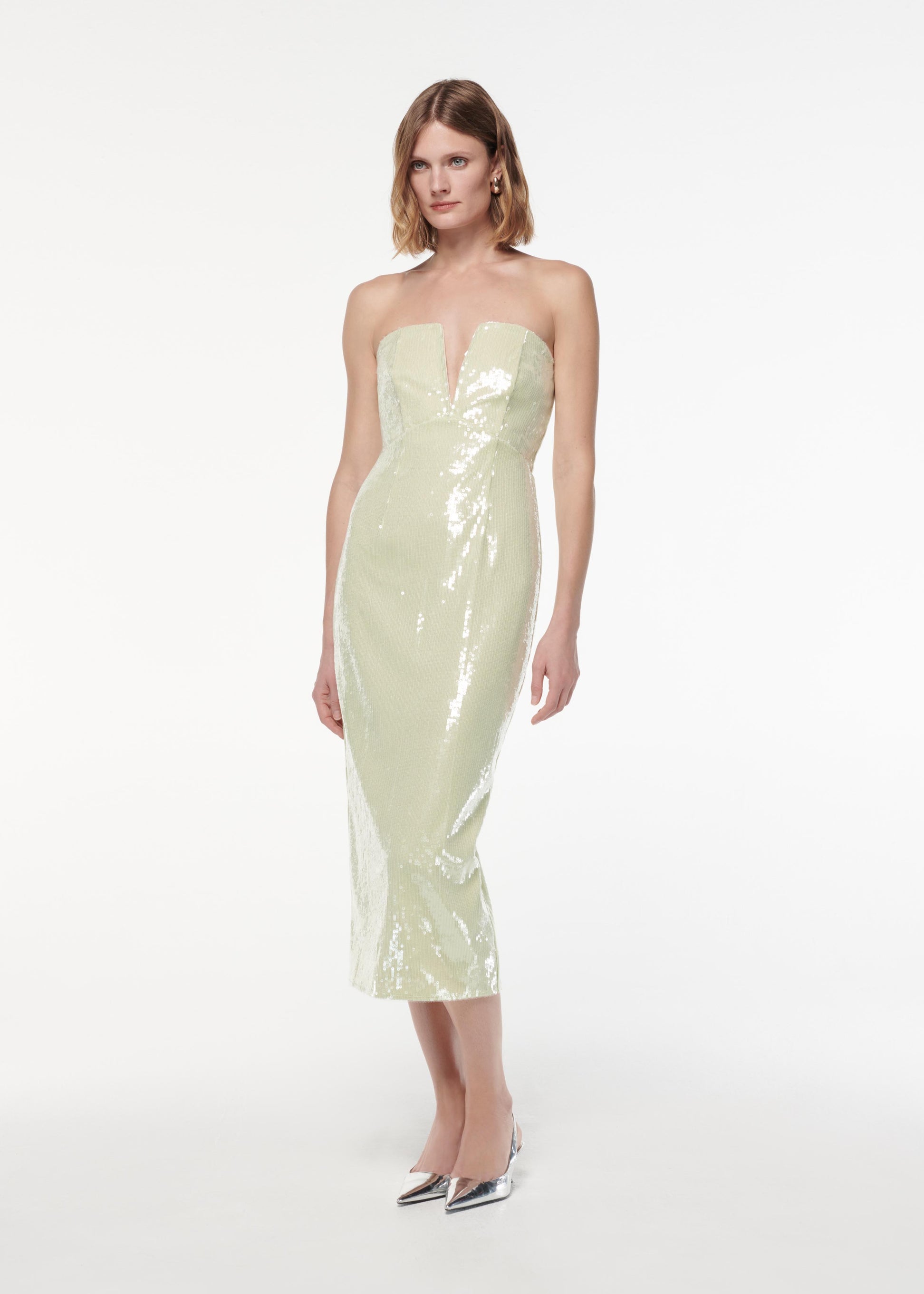 A photograph of a woman wearing a Strapless V Neck Sequin Midi Dress in Green