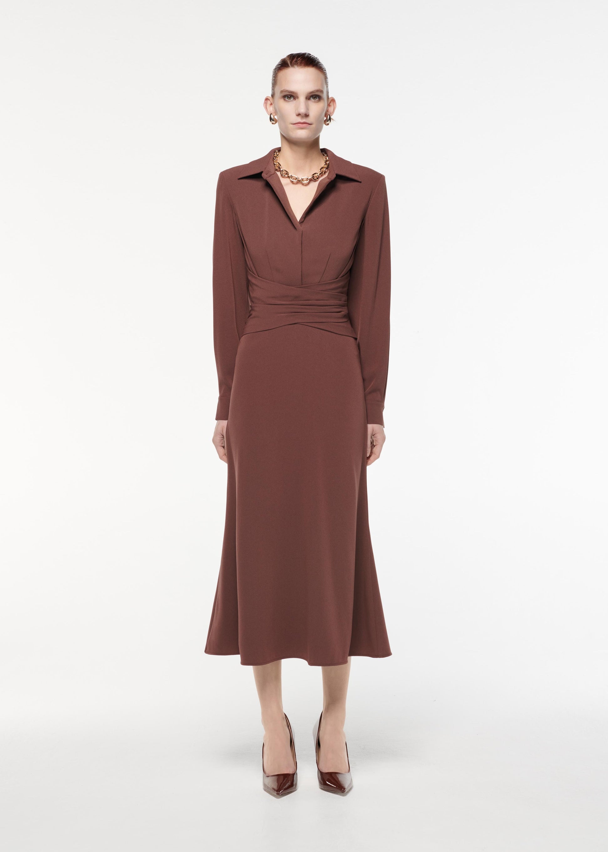 A photograph of a woman wearing a Long Sleeve Satin Crepe Collar Midi Dress in Brown