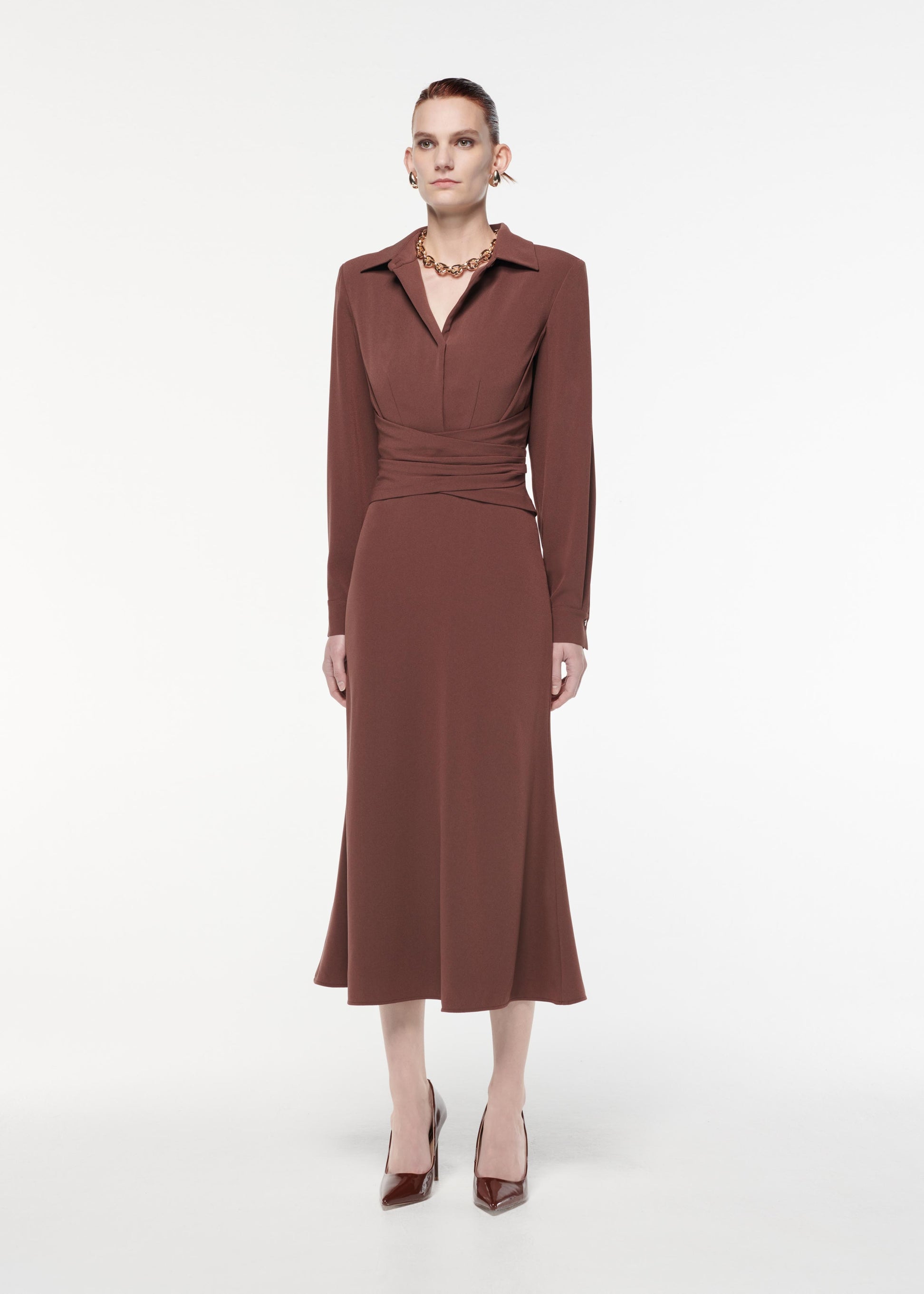 A photograph of a woman wearing a Long Sleeve Satin Crepe Collar Midi Dress in Brown