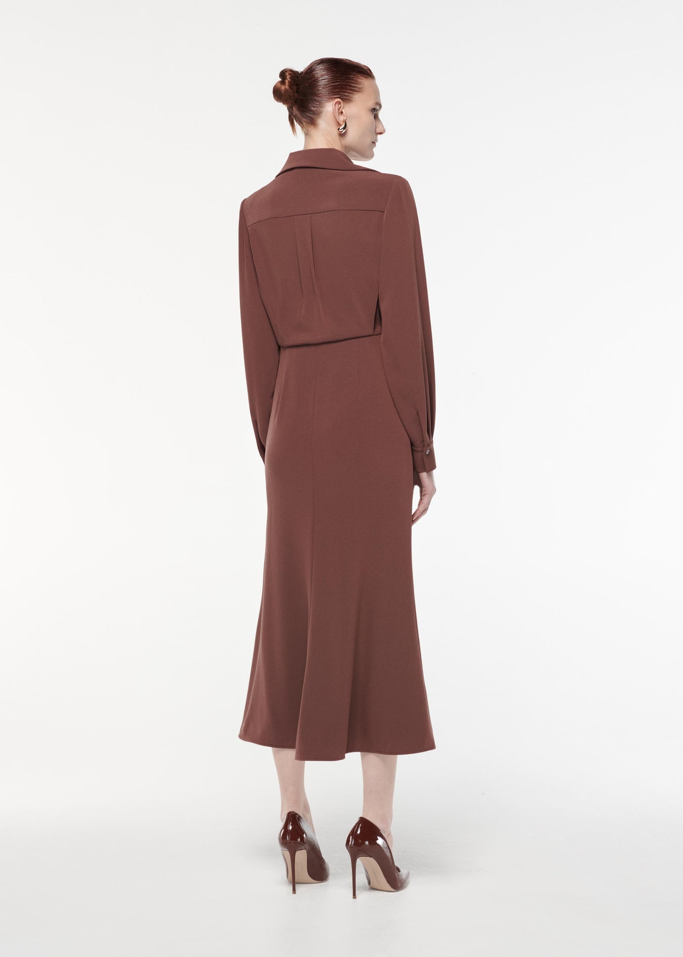 A photograph of a woman wearing a Long Sleeve Satin Crepe Collar Midi Dress in Brown