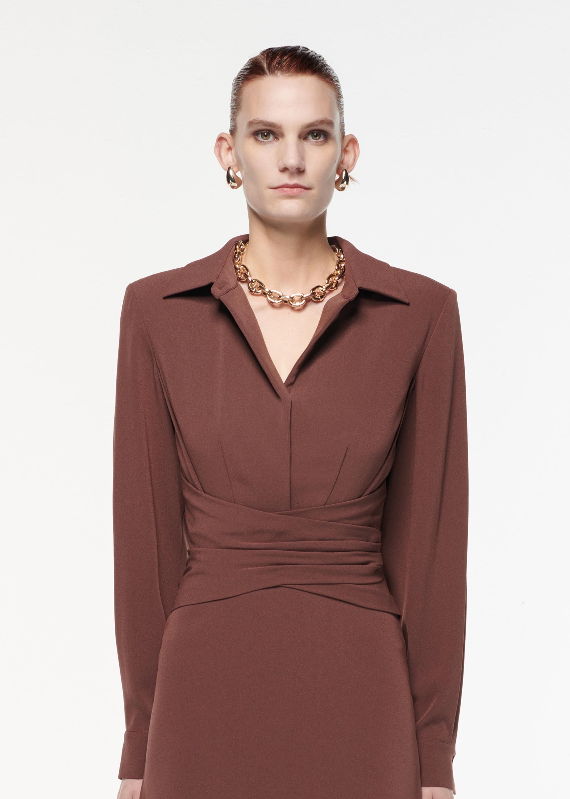 A photograph of a woman wearing a Long Sleeve Satin Crepe Collar Midi Dress in Brown