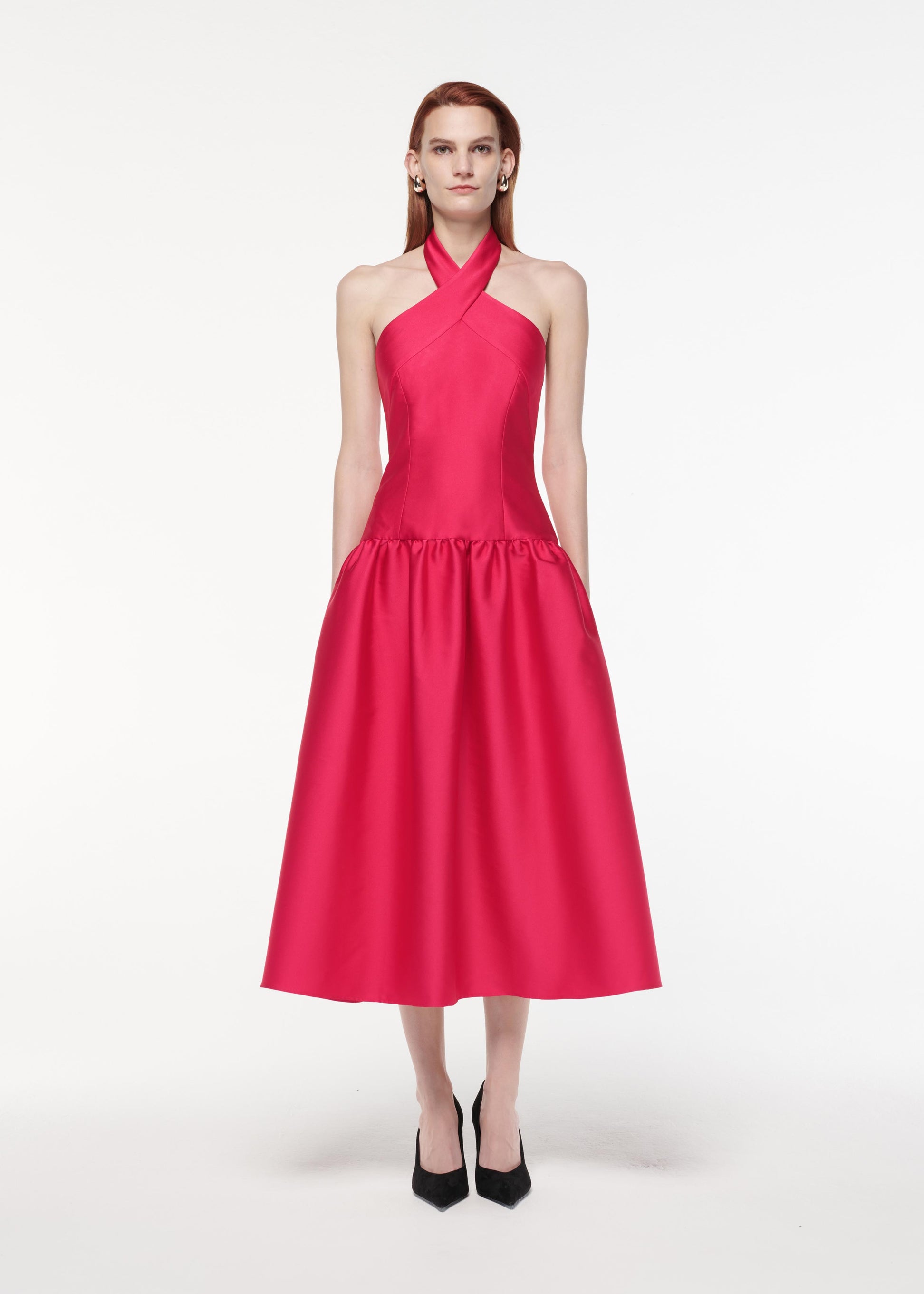 A photograph of a woman wearing a Taffeta Midi Dress in Pink