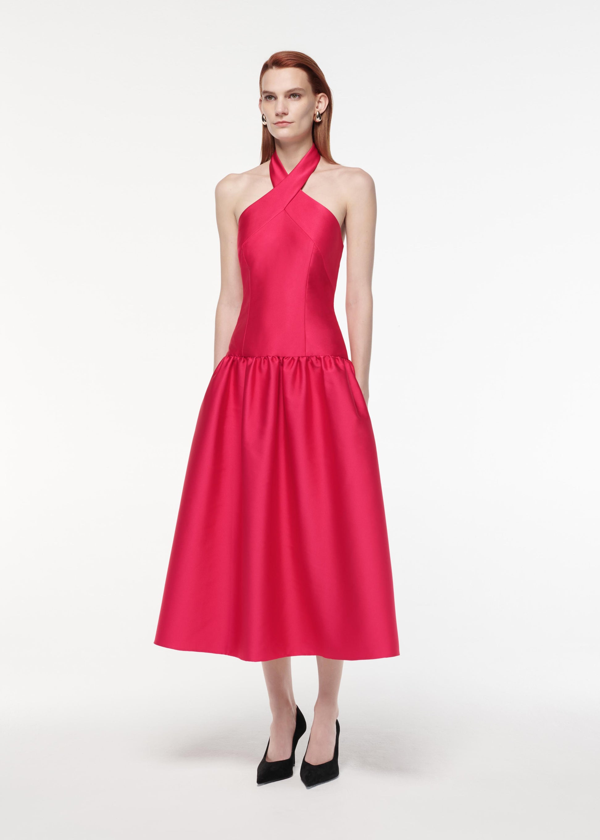 A photograph of a woman wearing a Taffeta Midi Dress in Pink