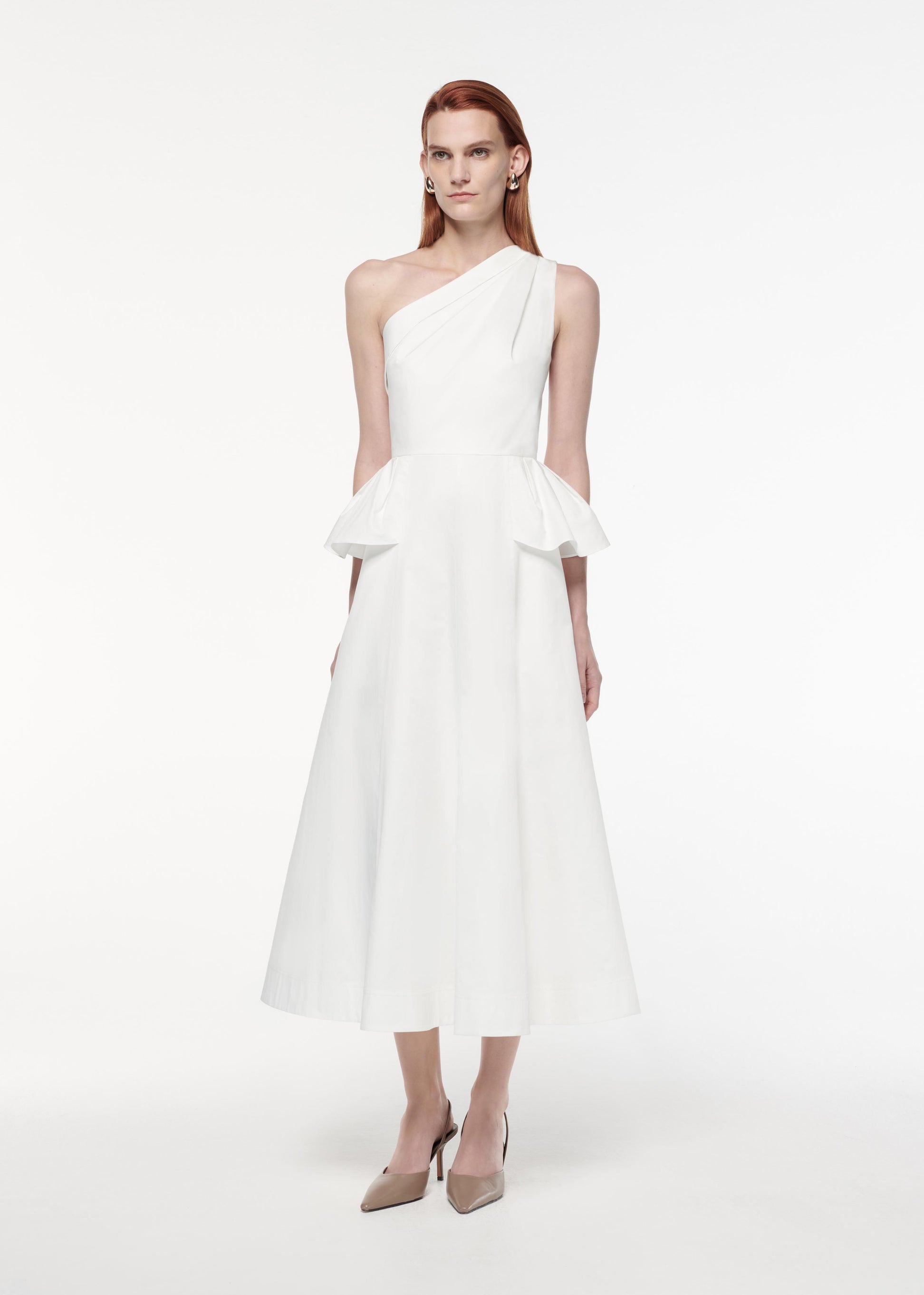 A photograph of a woman wearing a Asymmetric Hip Detail Dress in White