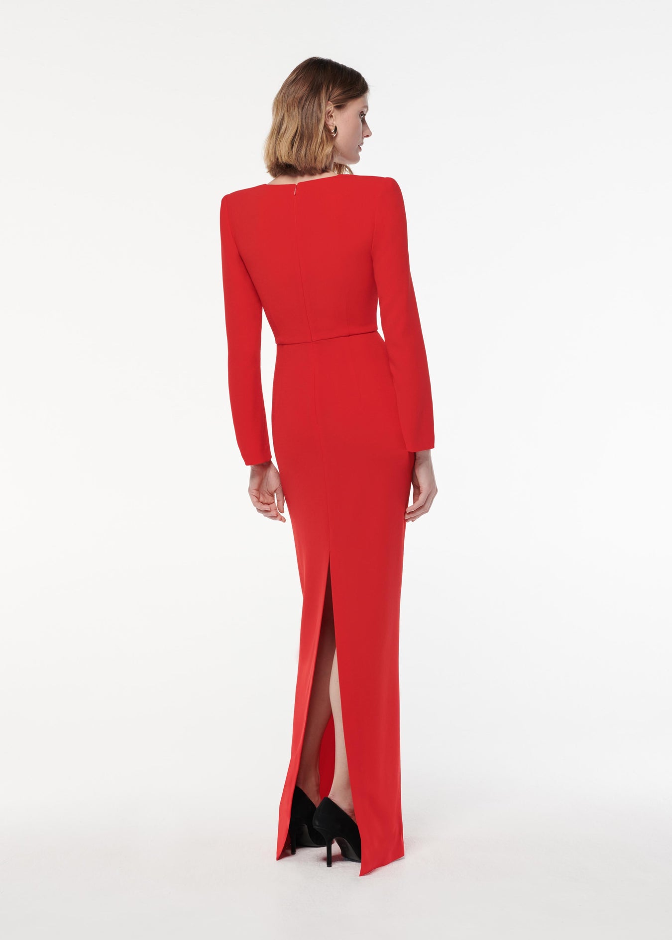 A photograph of a woman wearing a Long Sleeve Light Cady Maxi Dress in Red