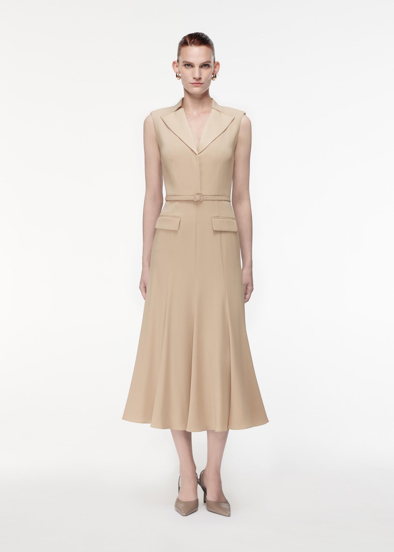 A photograph of a woman wearing a Satin Crepe Midi Dress in Taupe