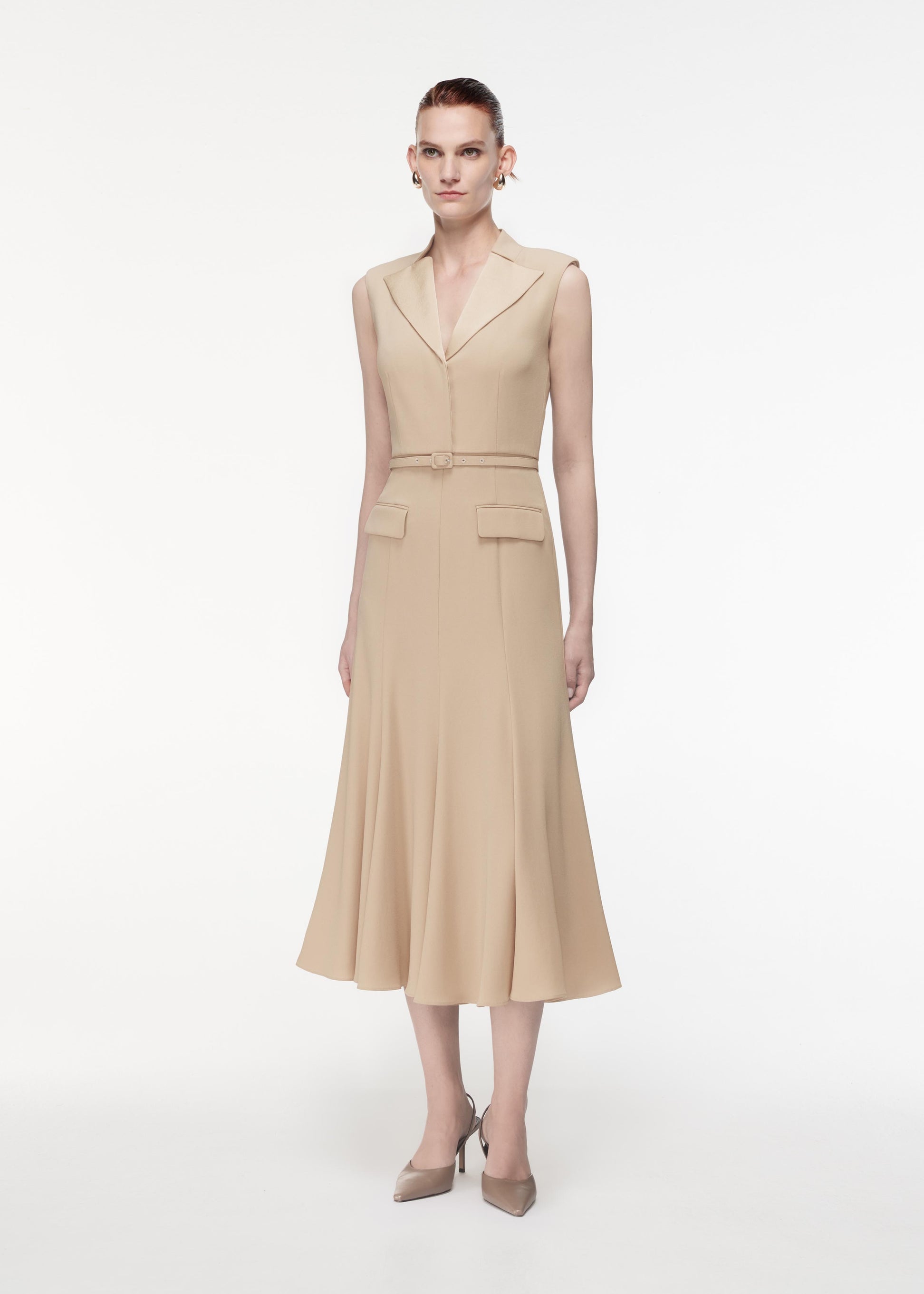 A photograph of a woman wearing a Satin Crepe Midi Dress in Taupe