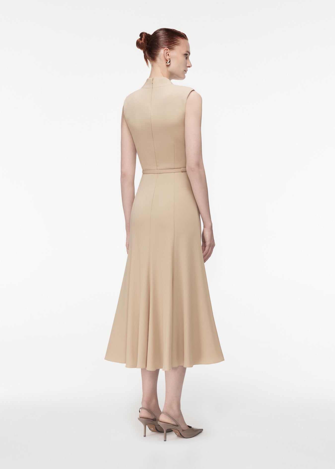 A photograph of a woman wearing a Satin Crepe Midi Dress in Taupe
