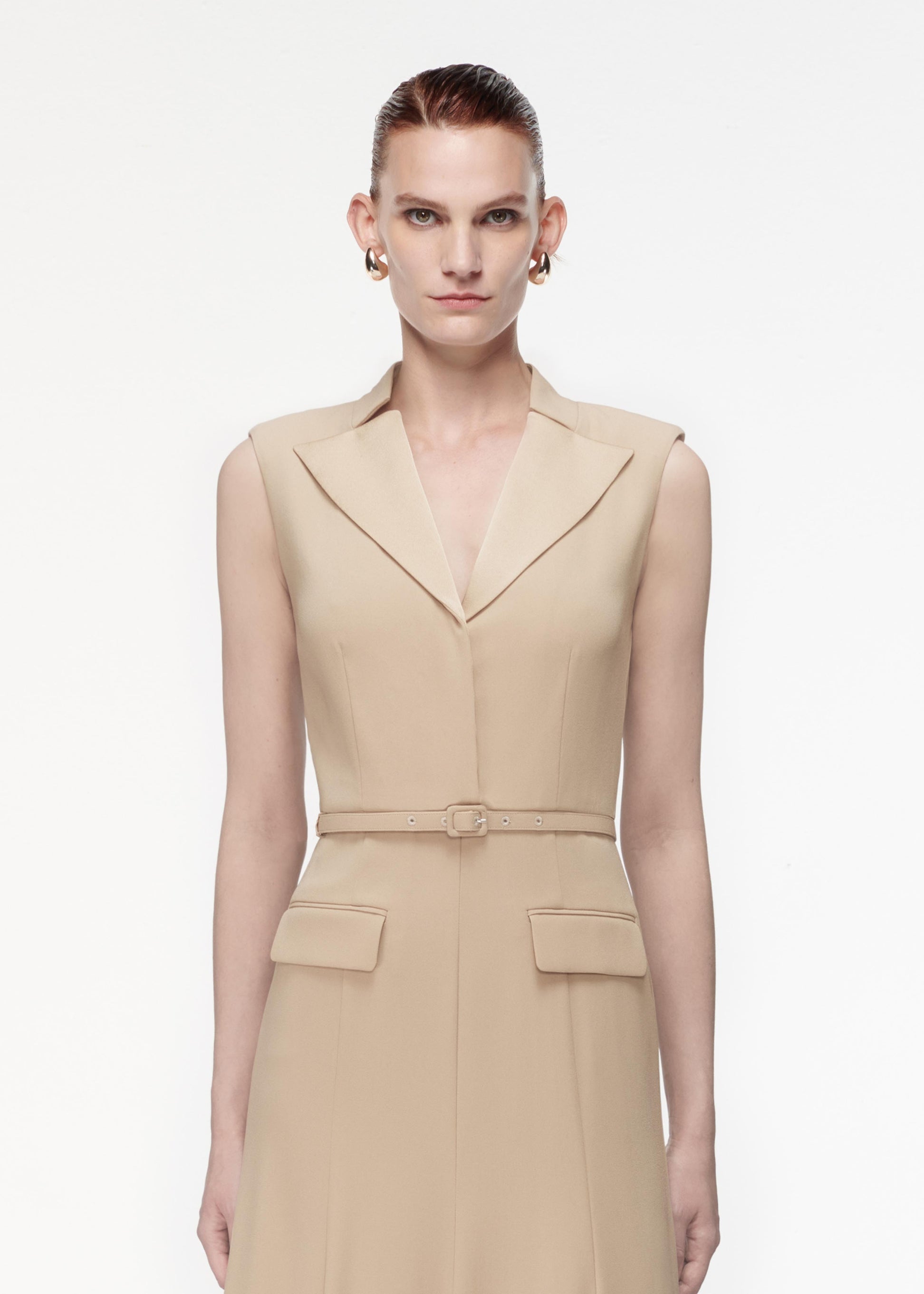 A photograph of a woman wearing a Satin Crepe Midi Dress in Taupe