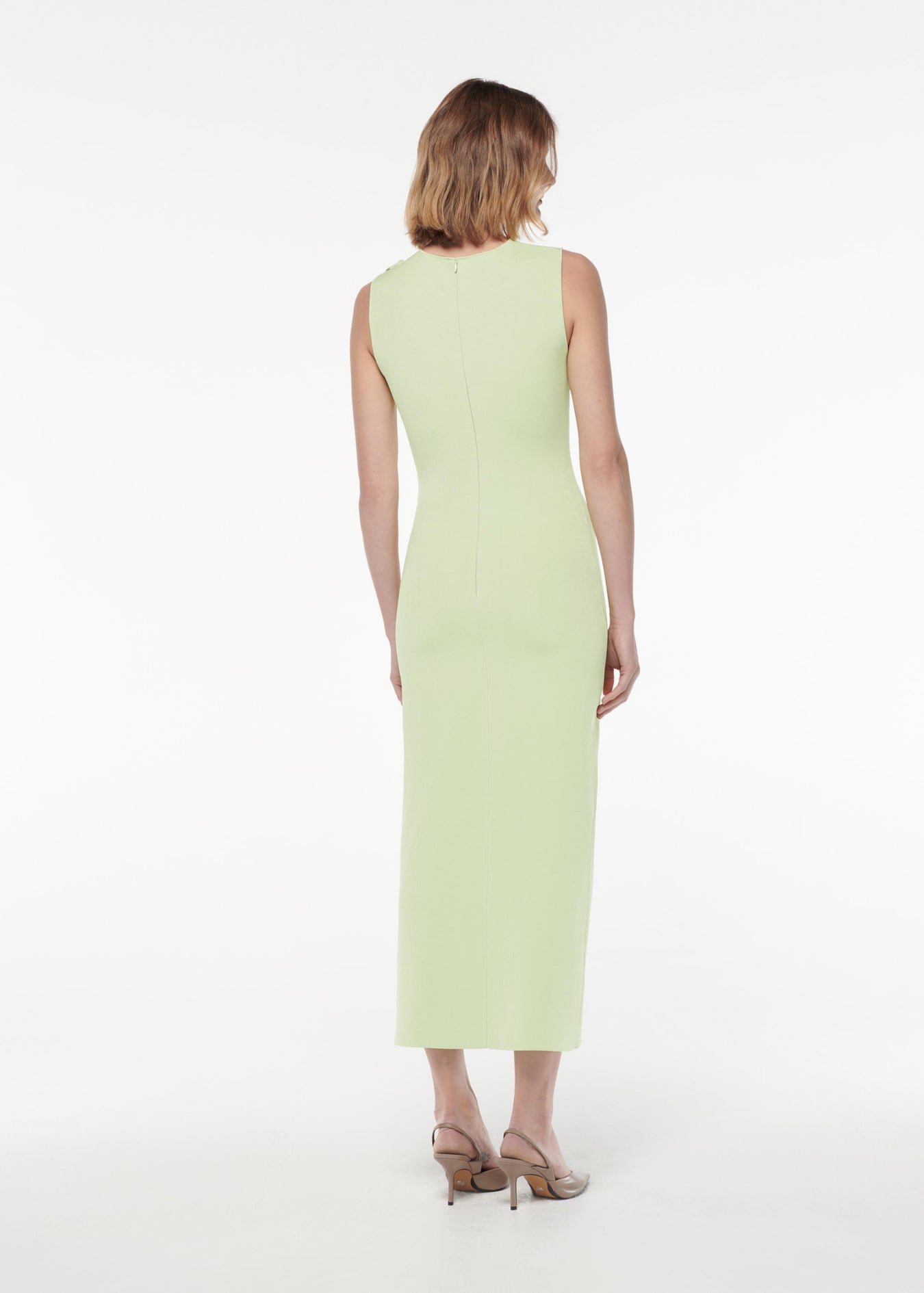 A photograph of a woman wearing a Flat Knit Bow Midi Dress in Green