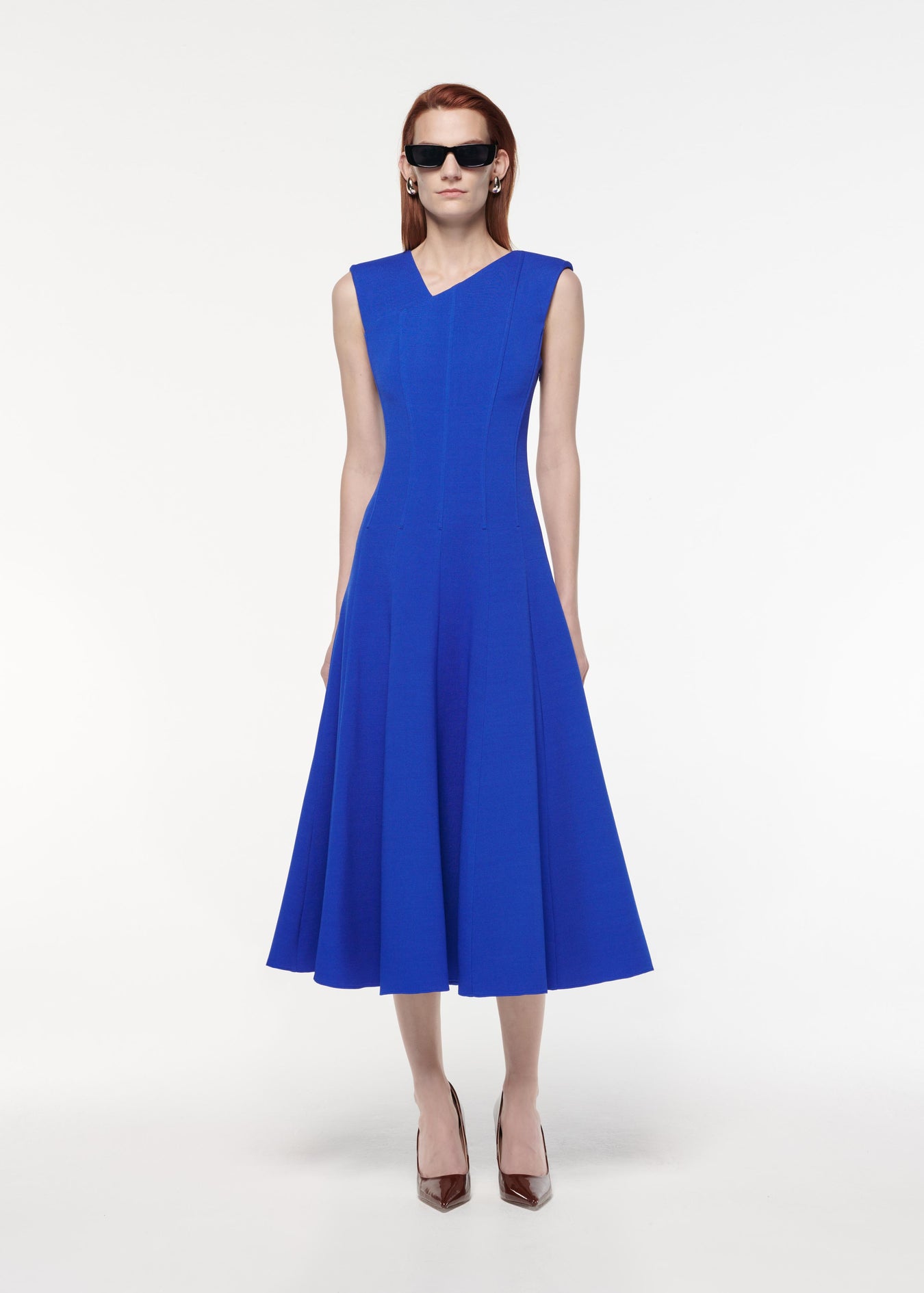 A photograph of a woman wearing a Stretch Wool Silk Midi Dress in Blue
