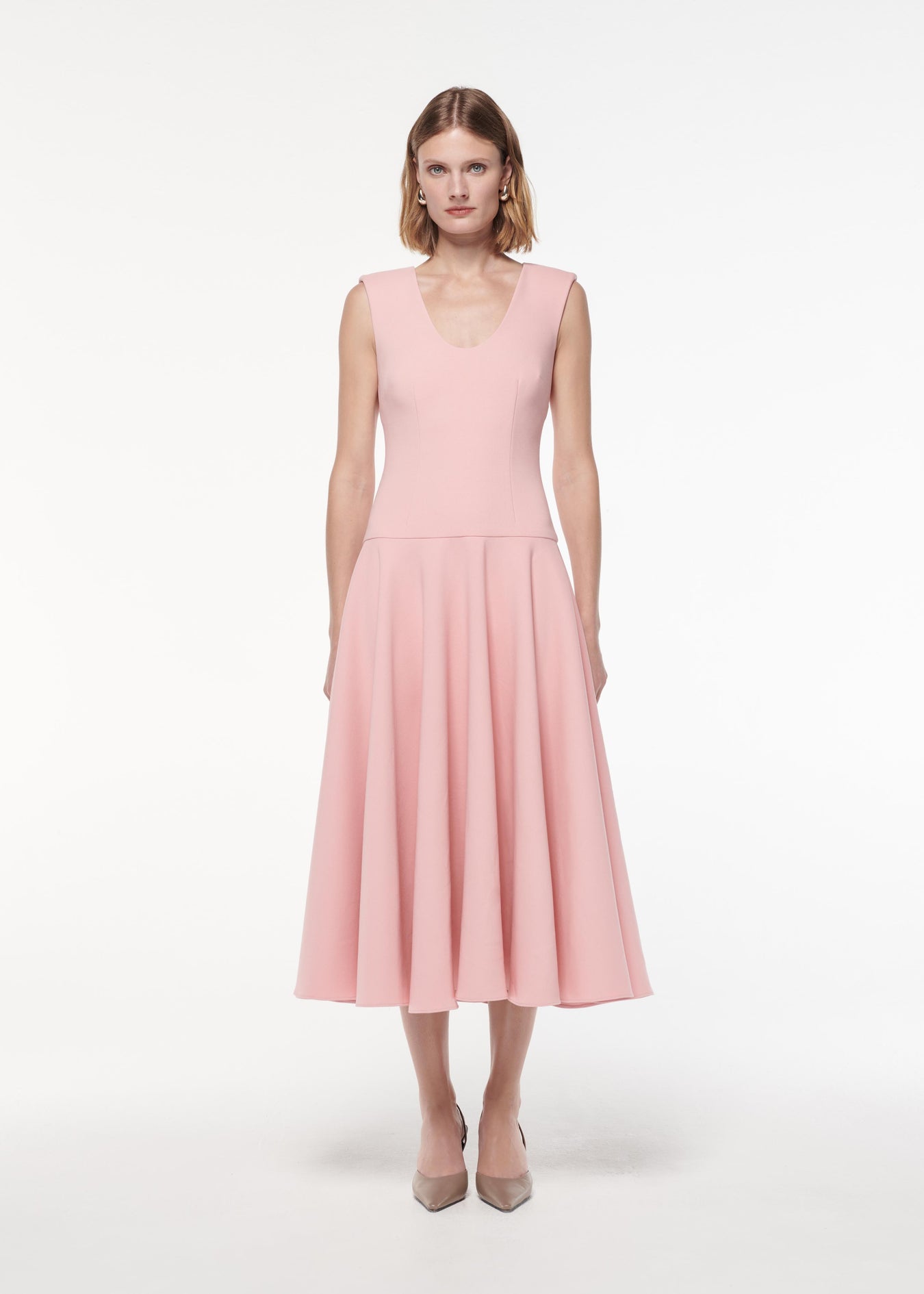 A photograph of a woman wearing a Drop Waist Detail Crepe Midi Dress in Pink