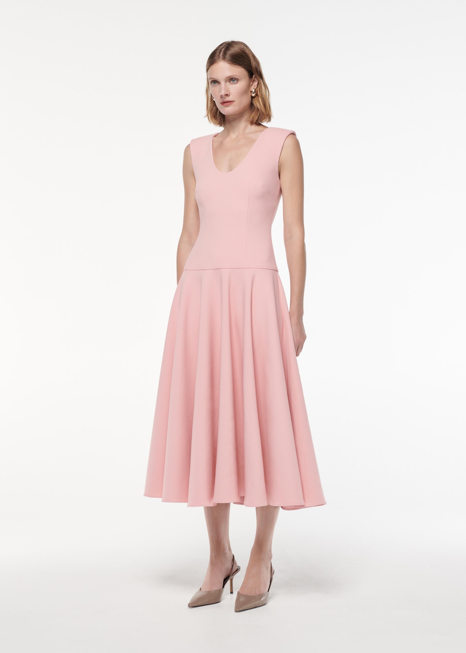 A photograph of a woman wearing a Drop Waist Detail Crepe Midi Dress in Pink