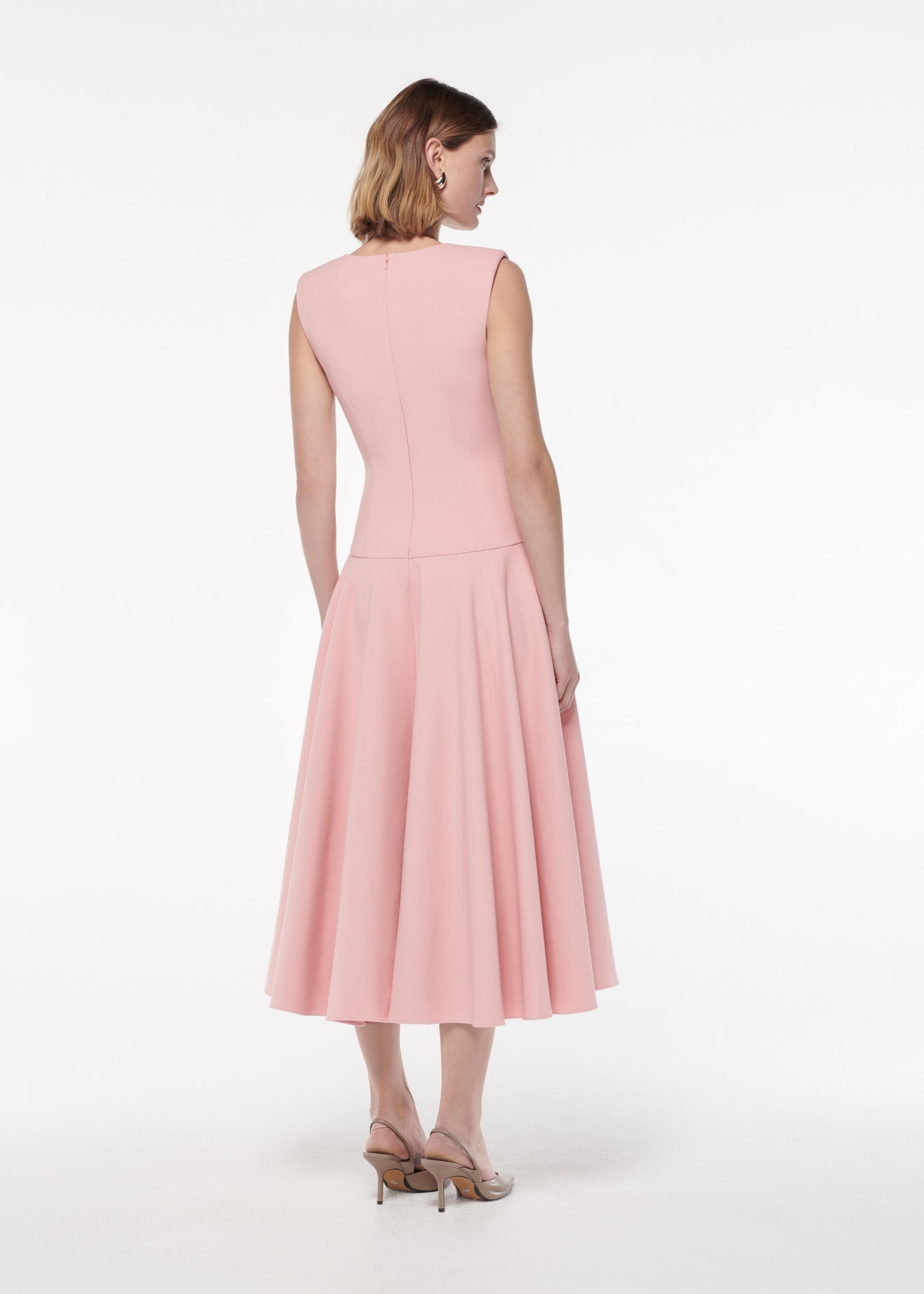 A photograph of a woman wearing a Drop Waist Detail Crepe Midi Dress in Pink