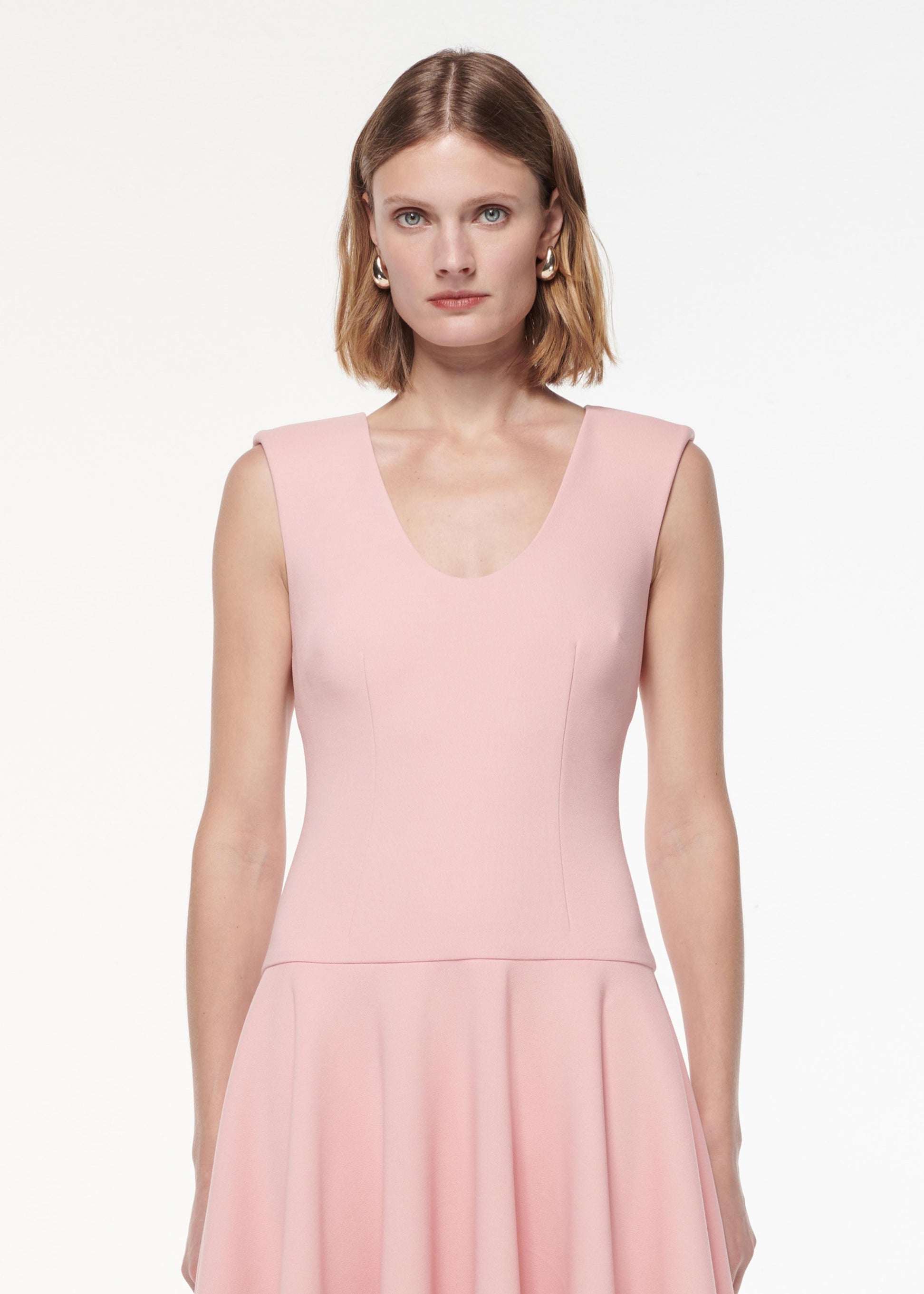 A photograph of a woman wearing a Drop Waist Detail Crepe Midi Dress in Pink