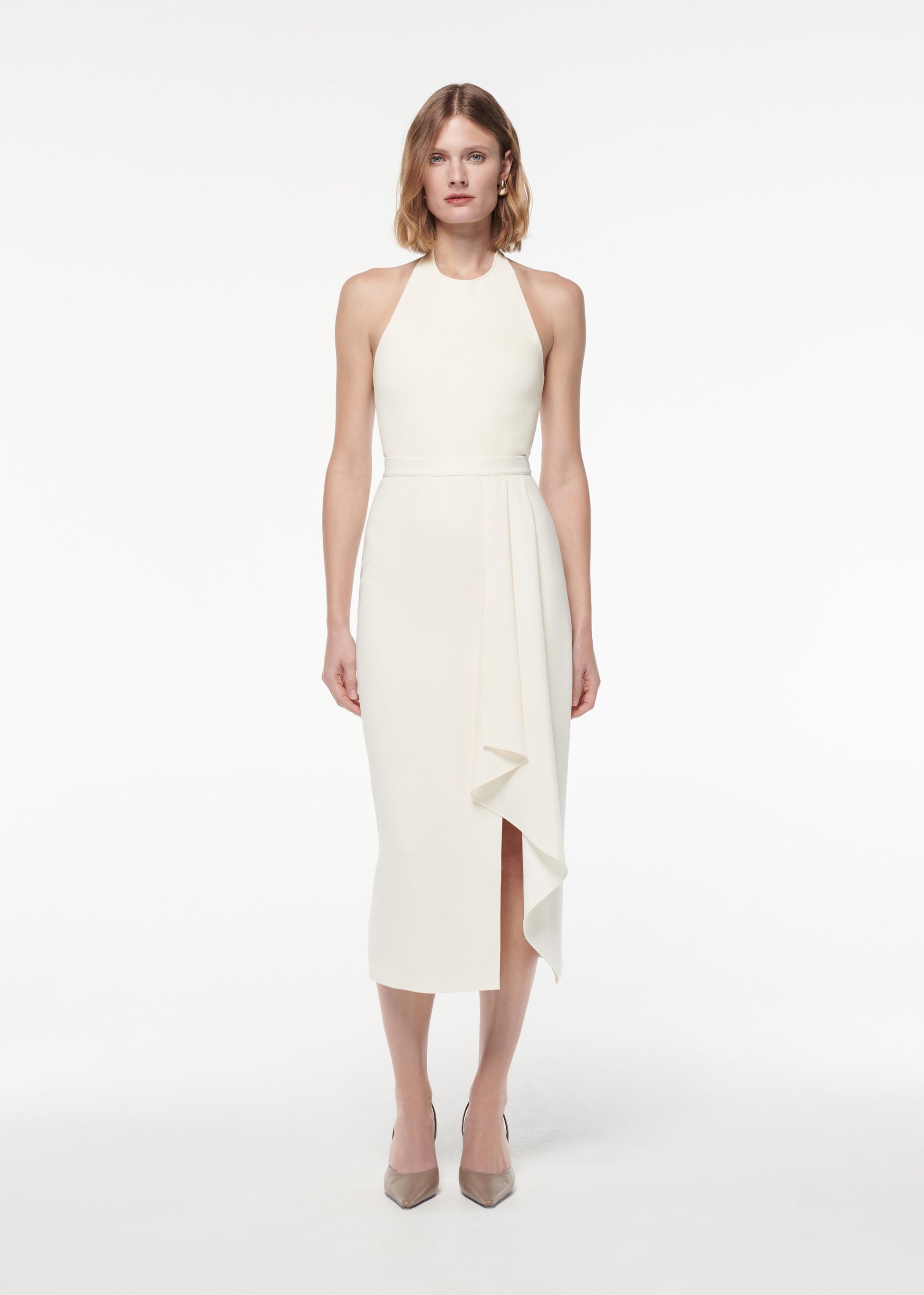 A photograph of a woman wearing a Ruffled Midi Skirt in Cream