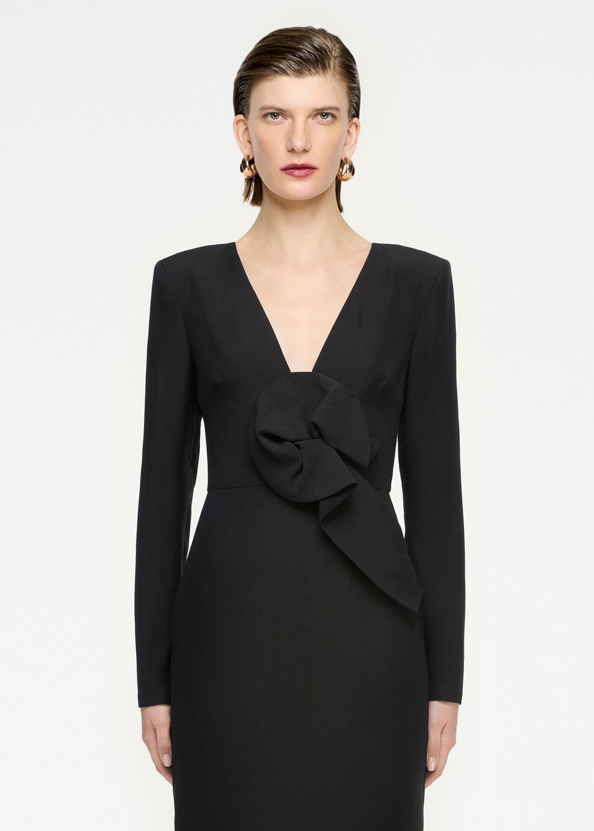 A close up of a woman wearing the Long Sleeve Wool Silk Midi Dress in Black
