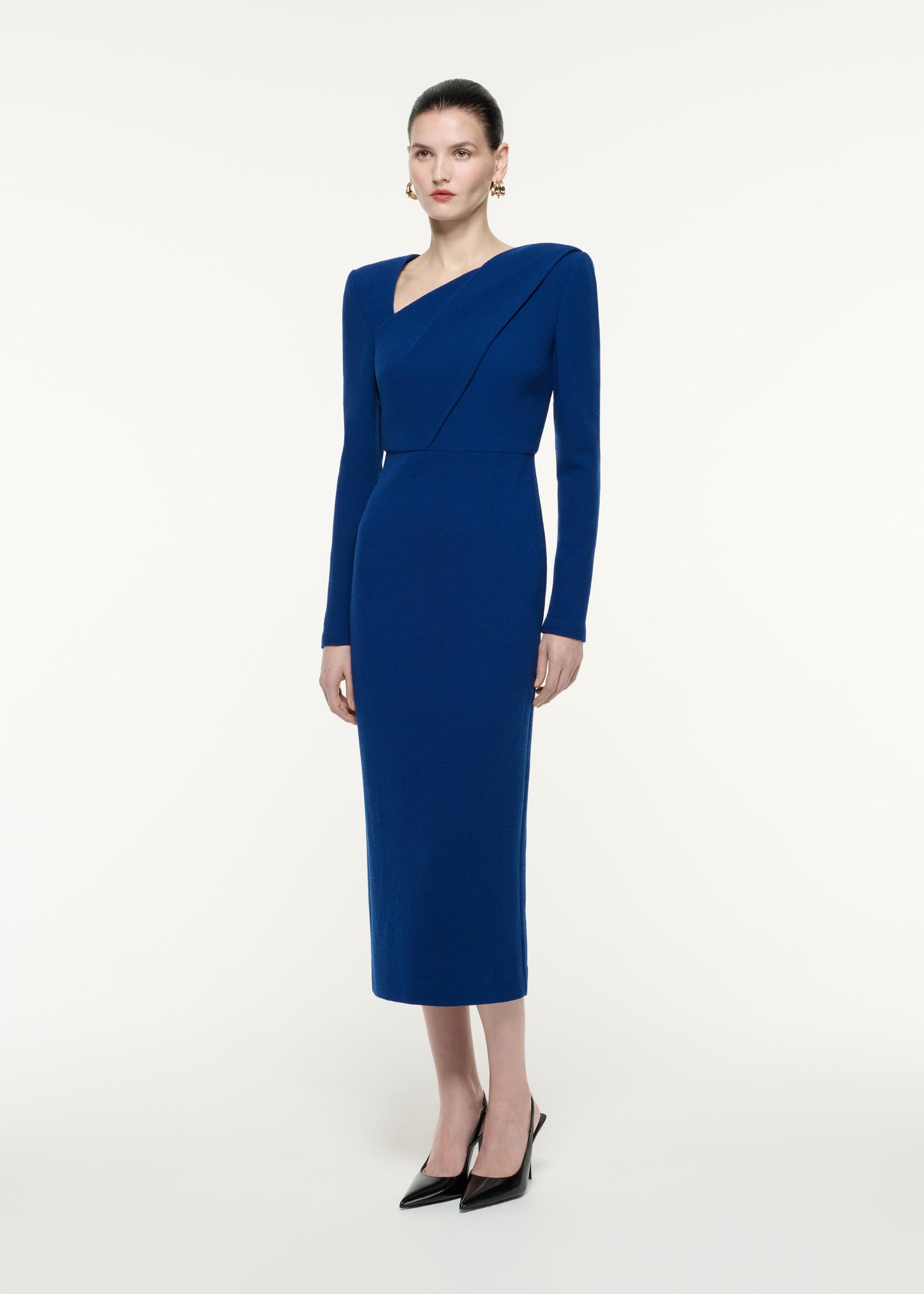 A side view image of a model wearing the Long Sleeve Wool Crepe Midi Dress in Navy
