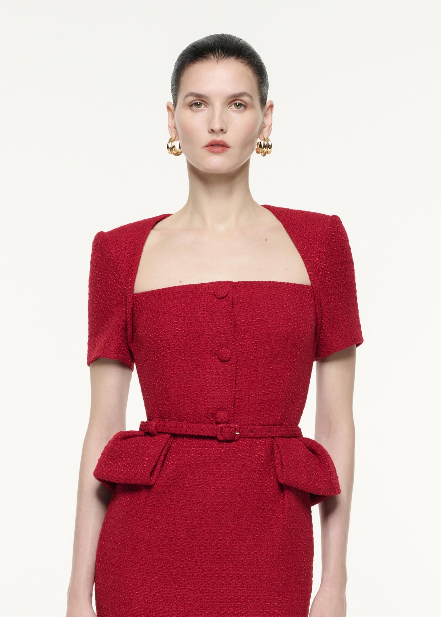 A close up image of a model wearing the Short Sleeve Boucle Midi Dress in Red