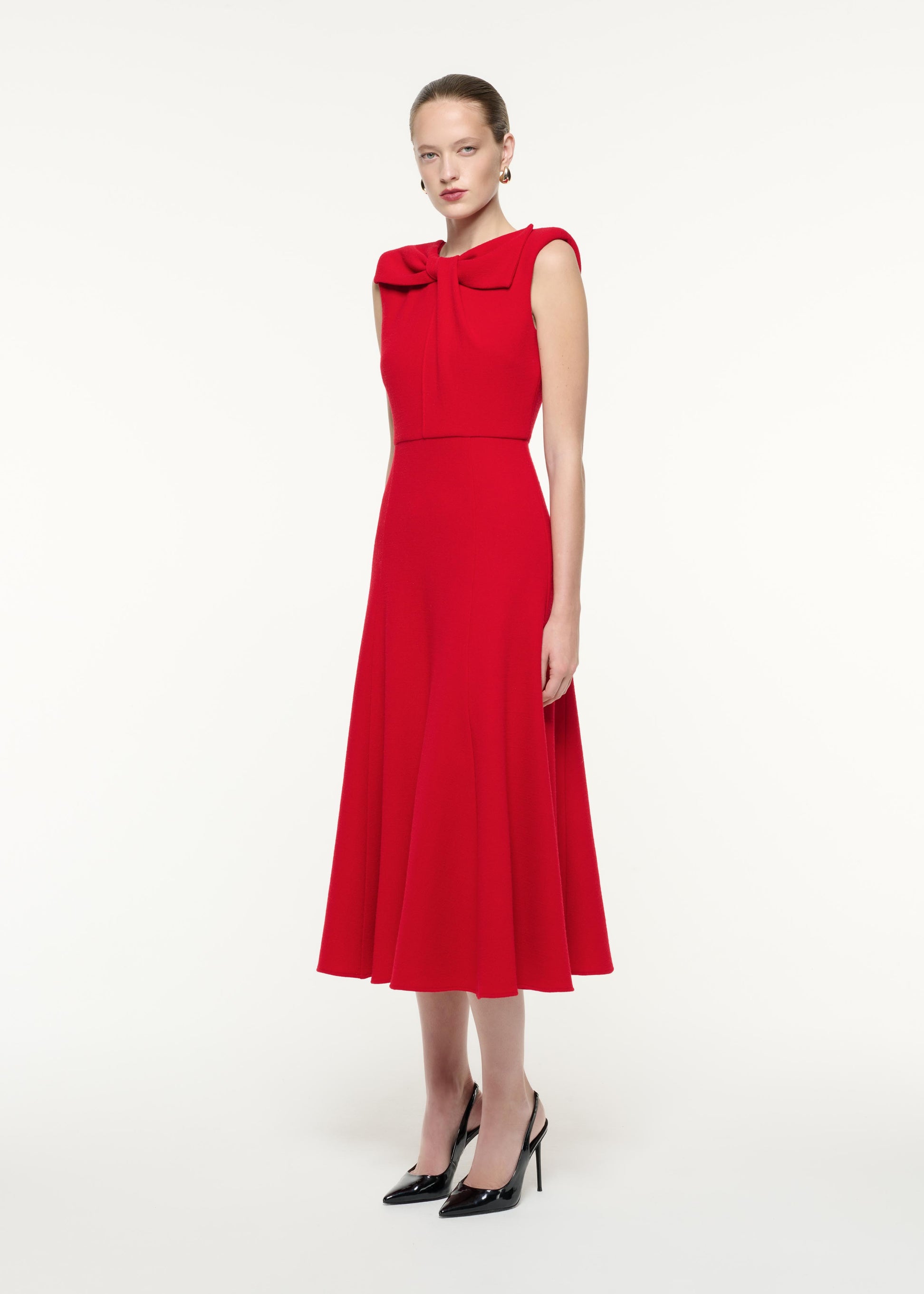 A side view image of a model wearing the Wool Crepe Midi Dress in Red
