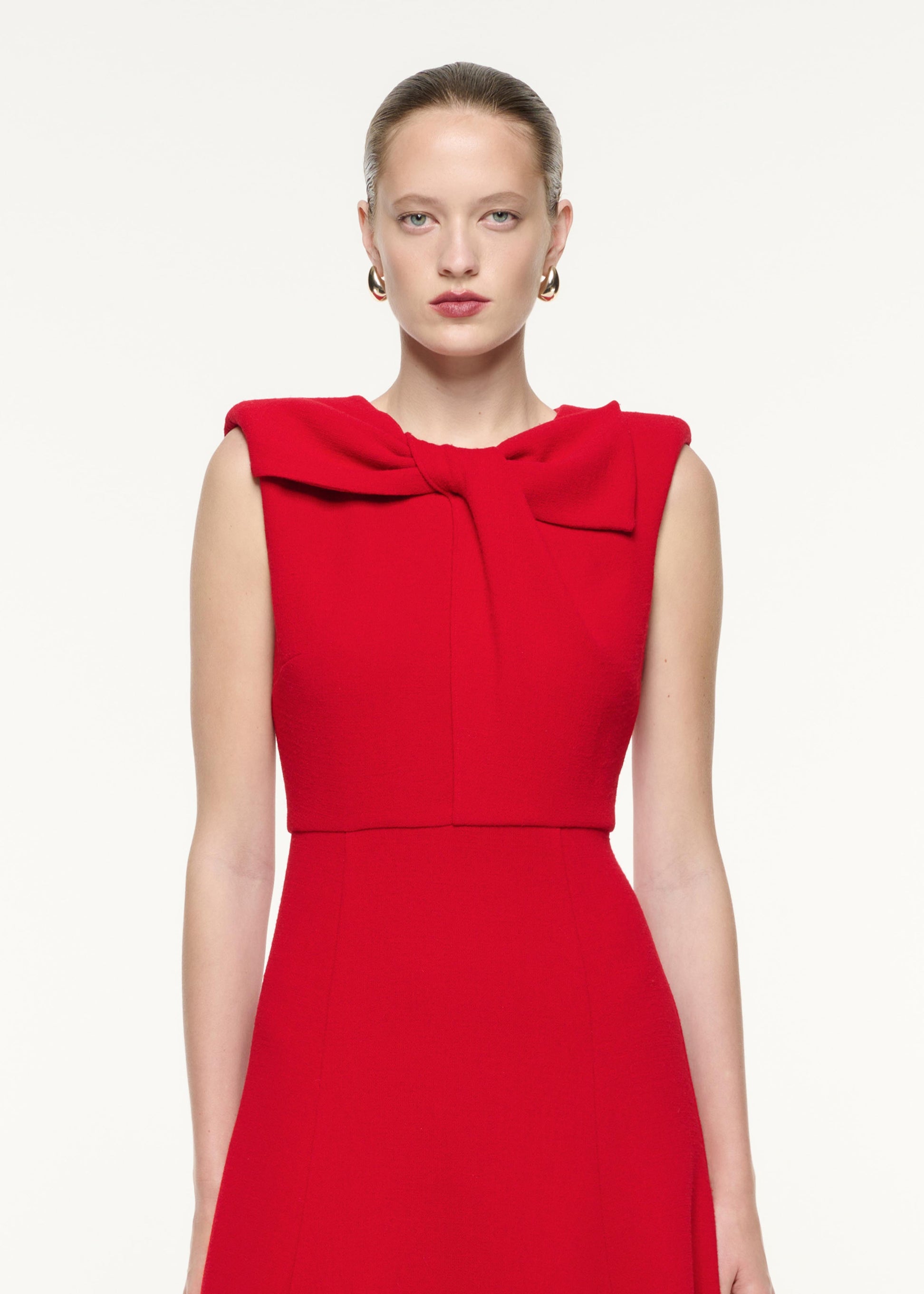 A close up image of a model wearing the Wool Crepe Midi Dress in Red