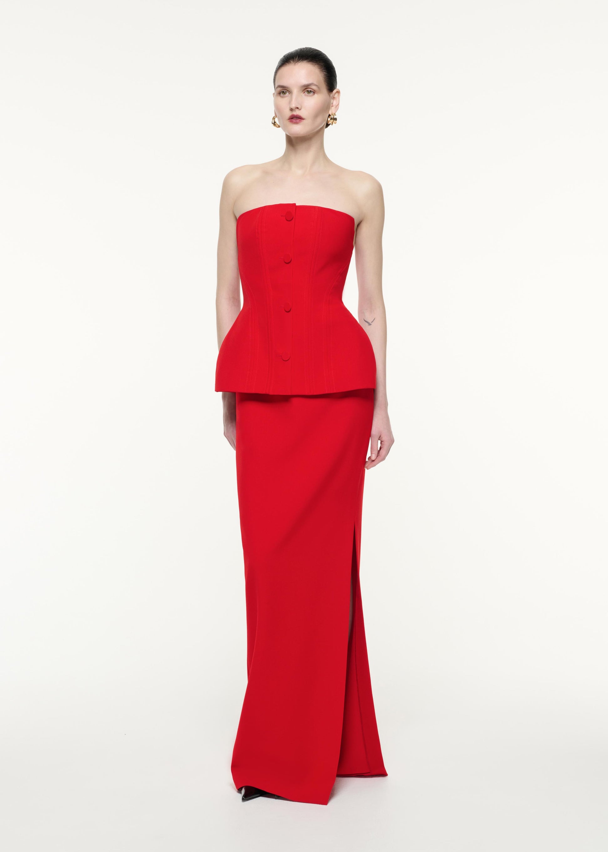 Side view of a model wearing the Strapless Tailored Crepe Gown in Red
