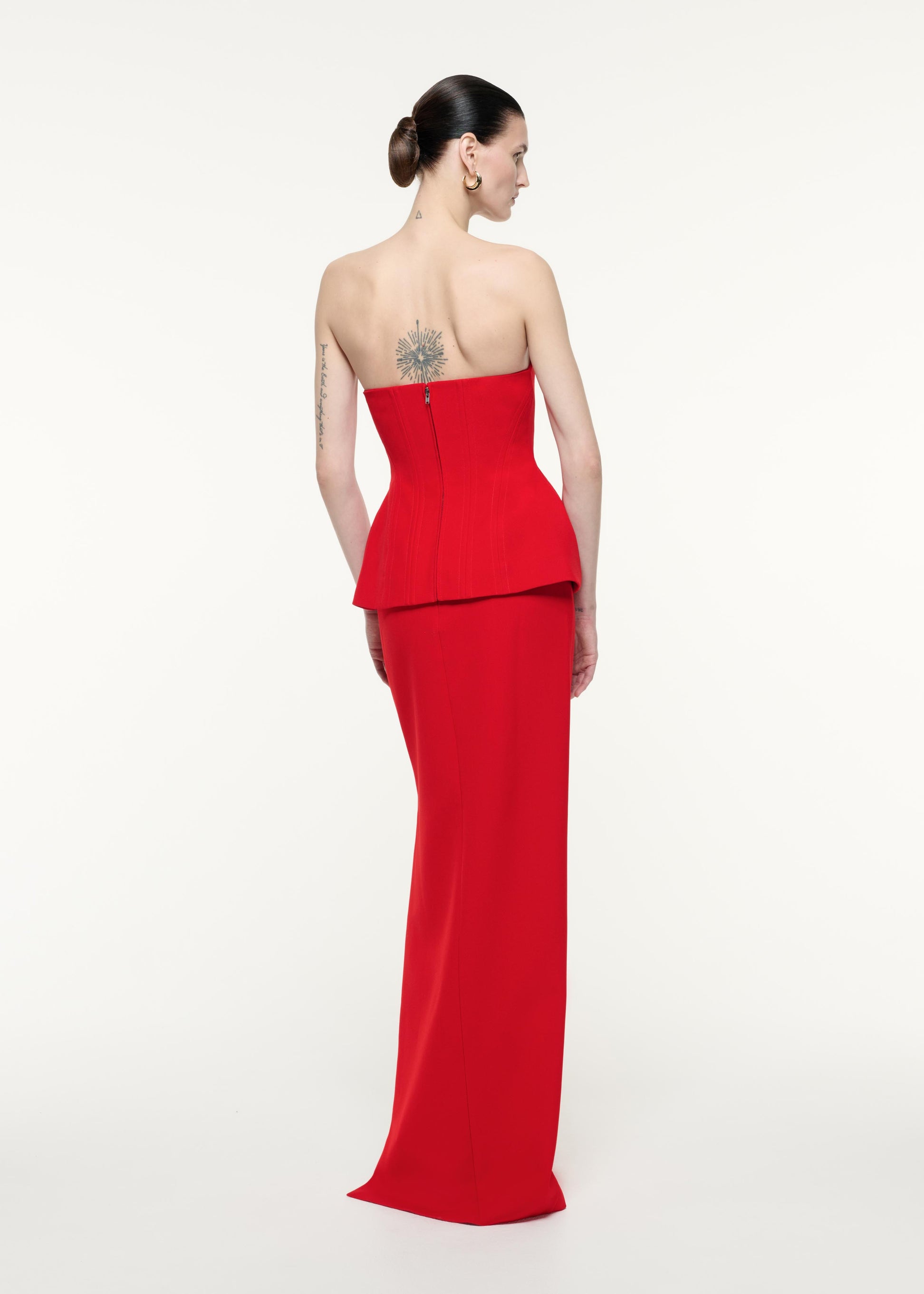 Back view of a model wearing the Strapless Tailored Crepe Gown in Red