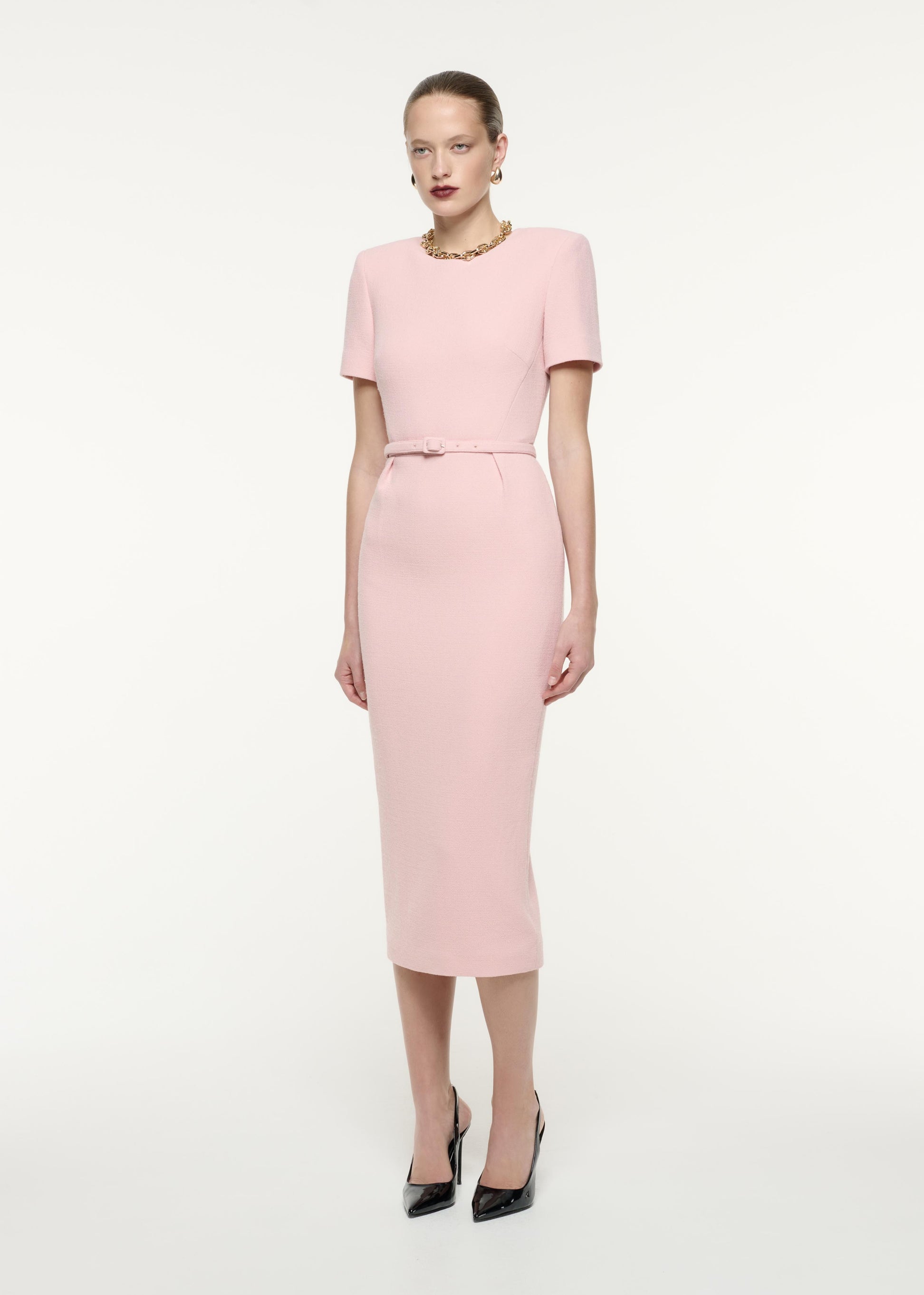 A side view image of a model wearing the Short Sleeve Wool Crepe Midi Dress in Pink