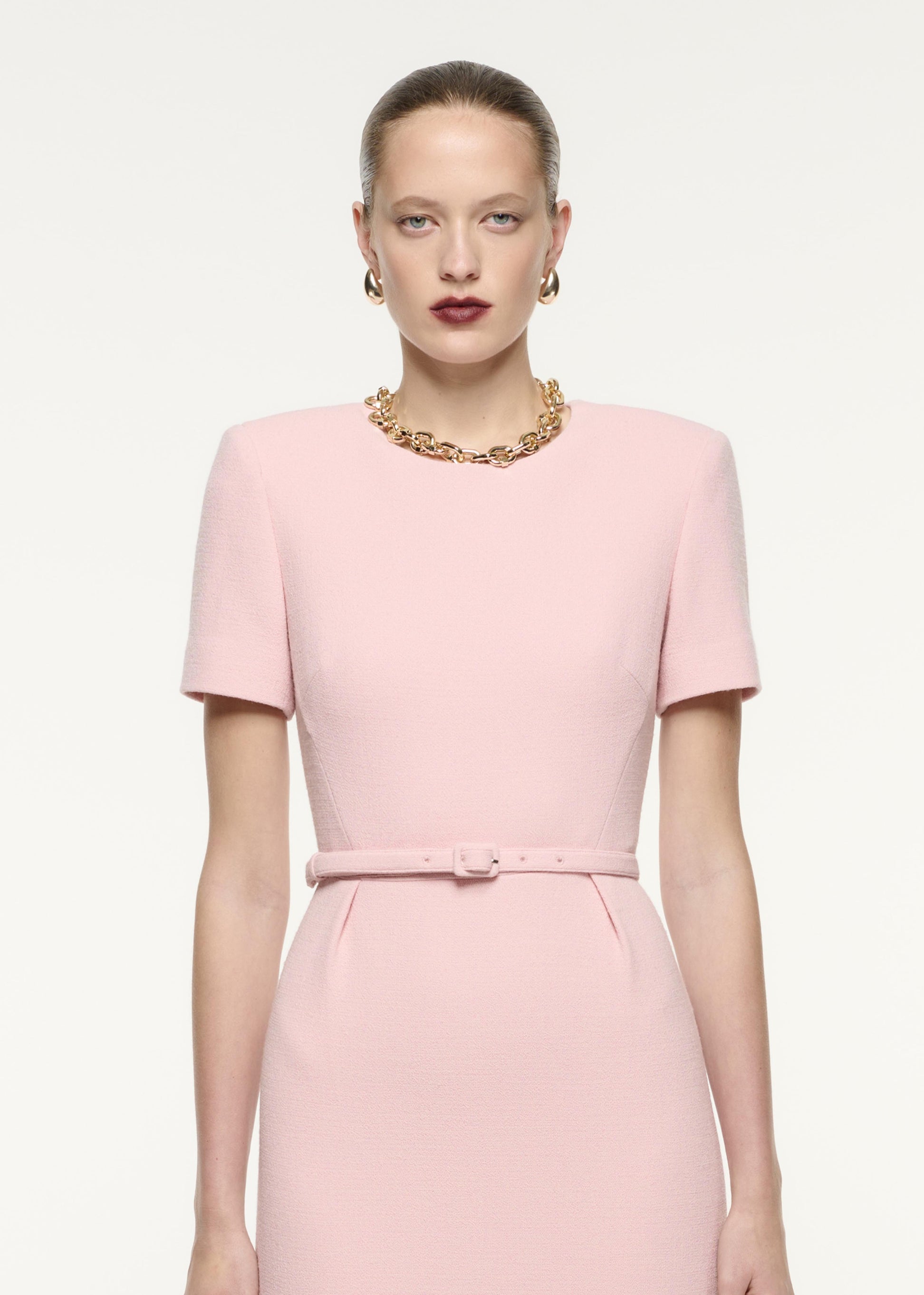 A close up image of a model wearing the Short Sleeve Wool Crepe Midi Dress in Pink