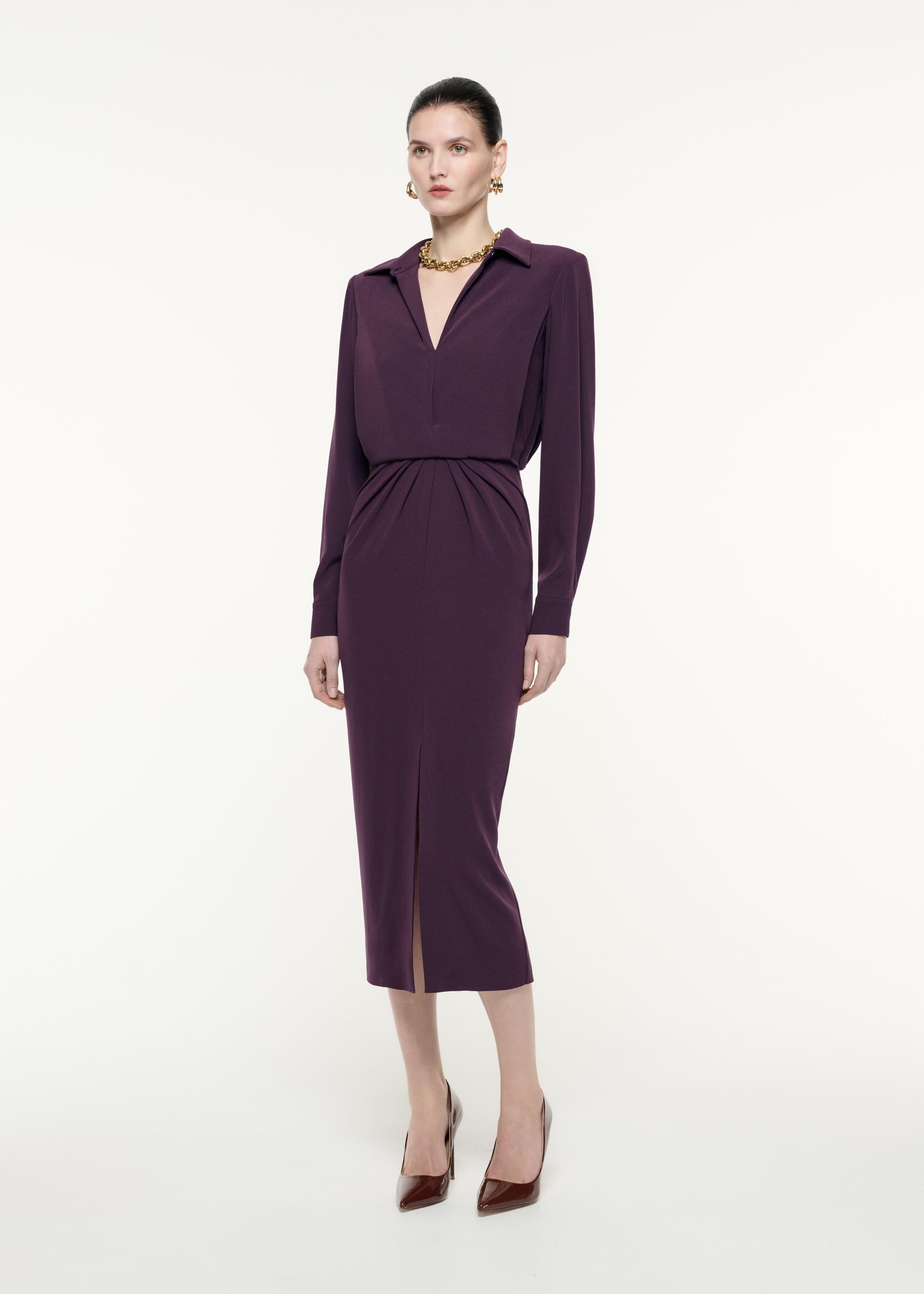 A side view image of a model wearing the Long Sleeve Satin Crepe Midi Dress in Aubergine