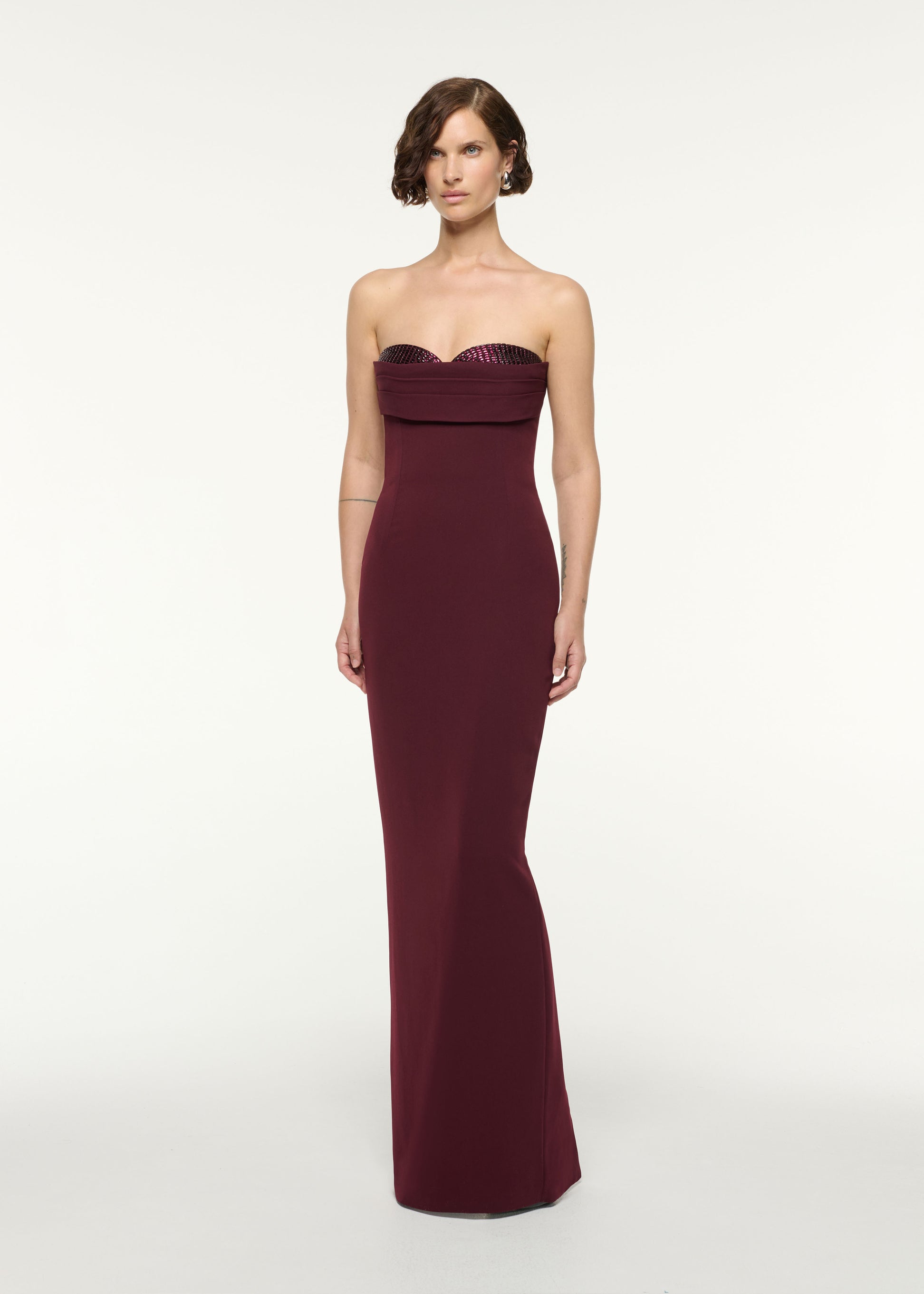 Side view of a model wearing the Diamante Peek-A-Boo Bust Column Gown in Mulberry