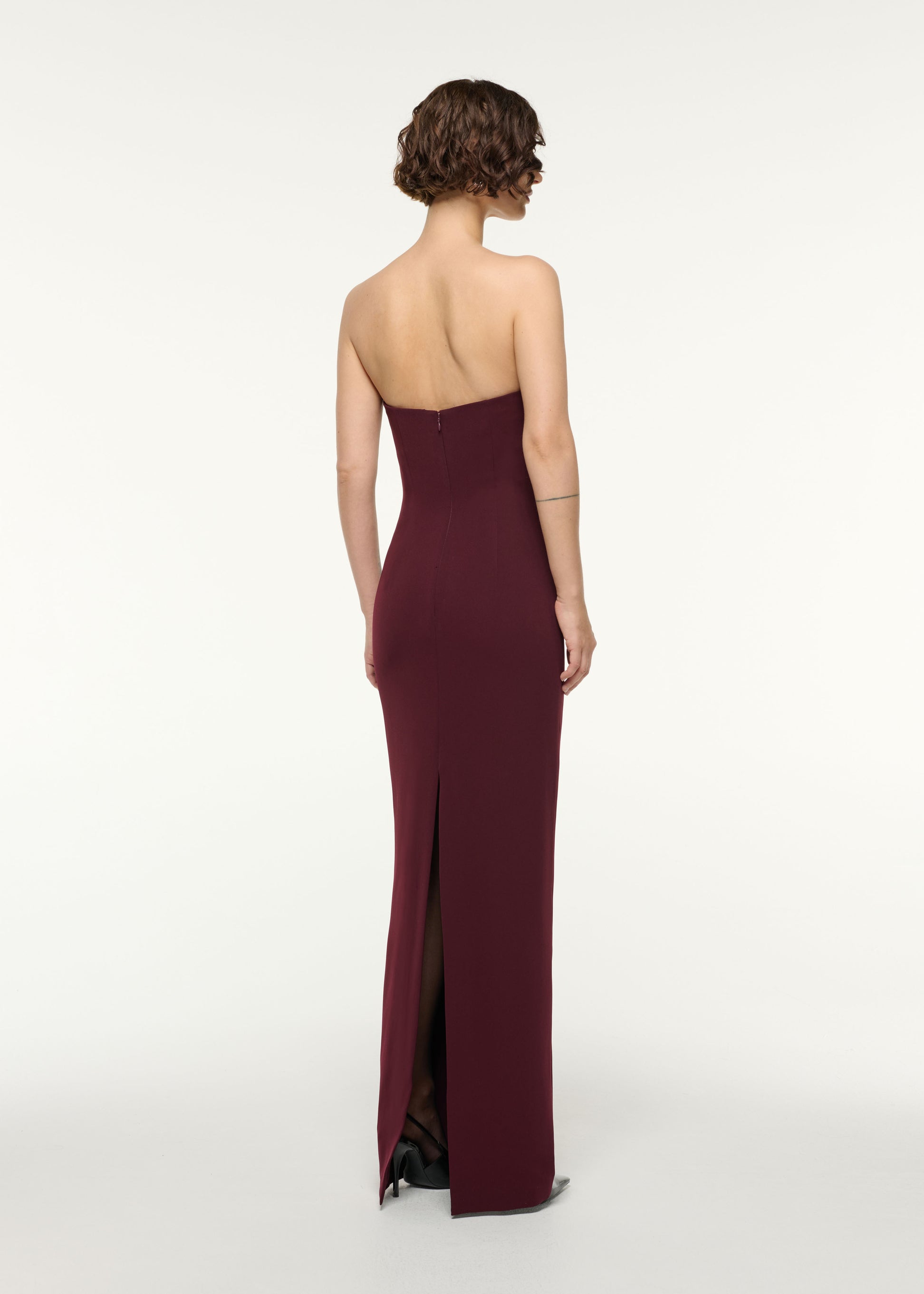 Back view of a model wearing the Diamante Peek-A-Boo Bust Column Gown in Mulberry