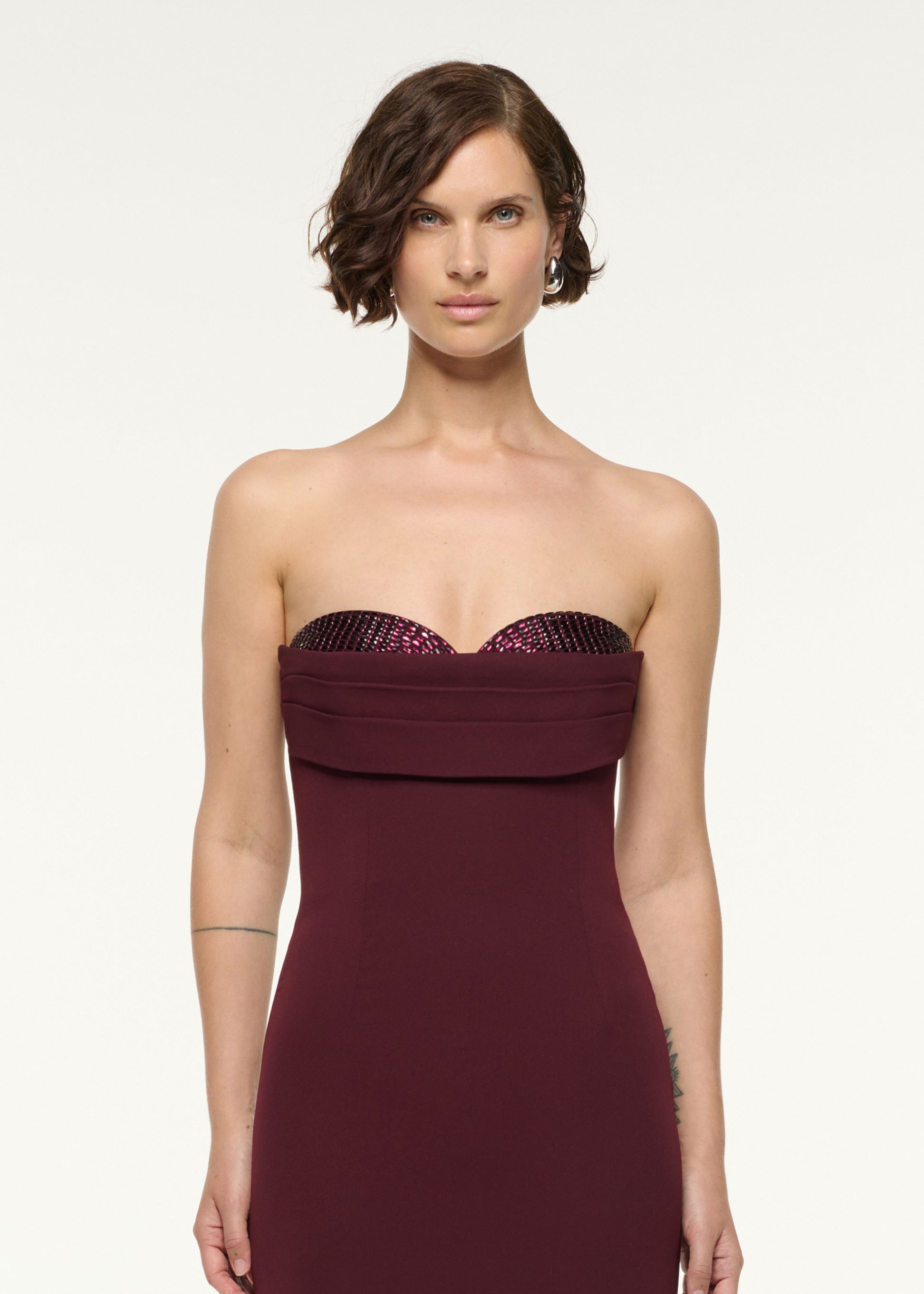 Close up of a model wearing the Diamante Peek-A-Boo Bust Column Gown in Mulberry