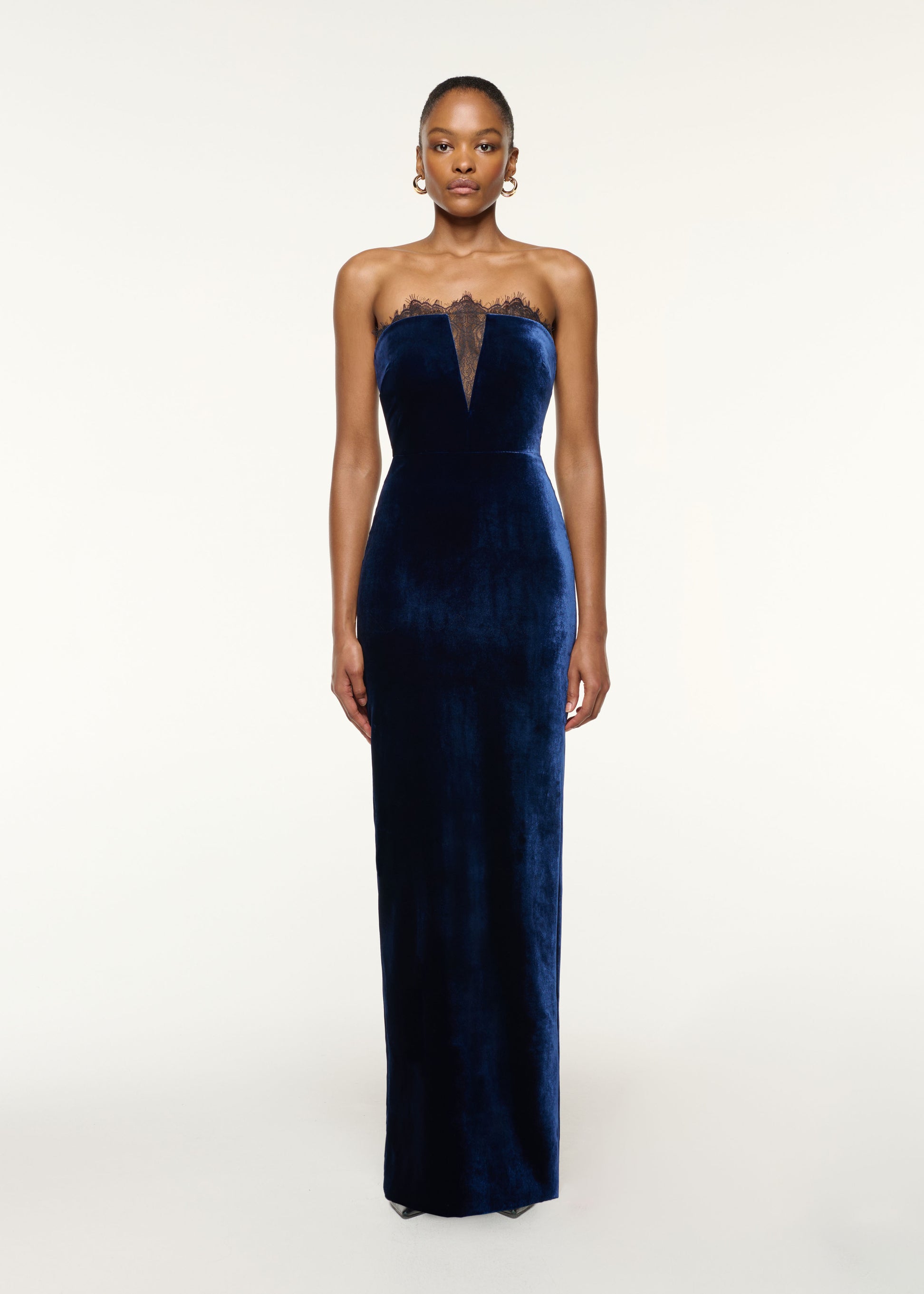 Front view of a model wearing the Scallop Lace Insert Velvet Column Gown in Navy