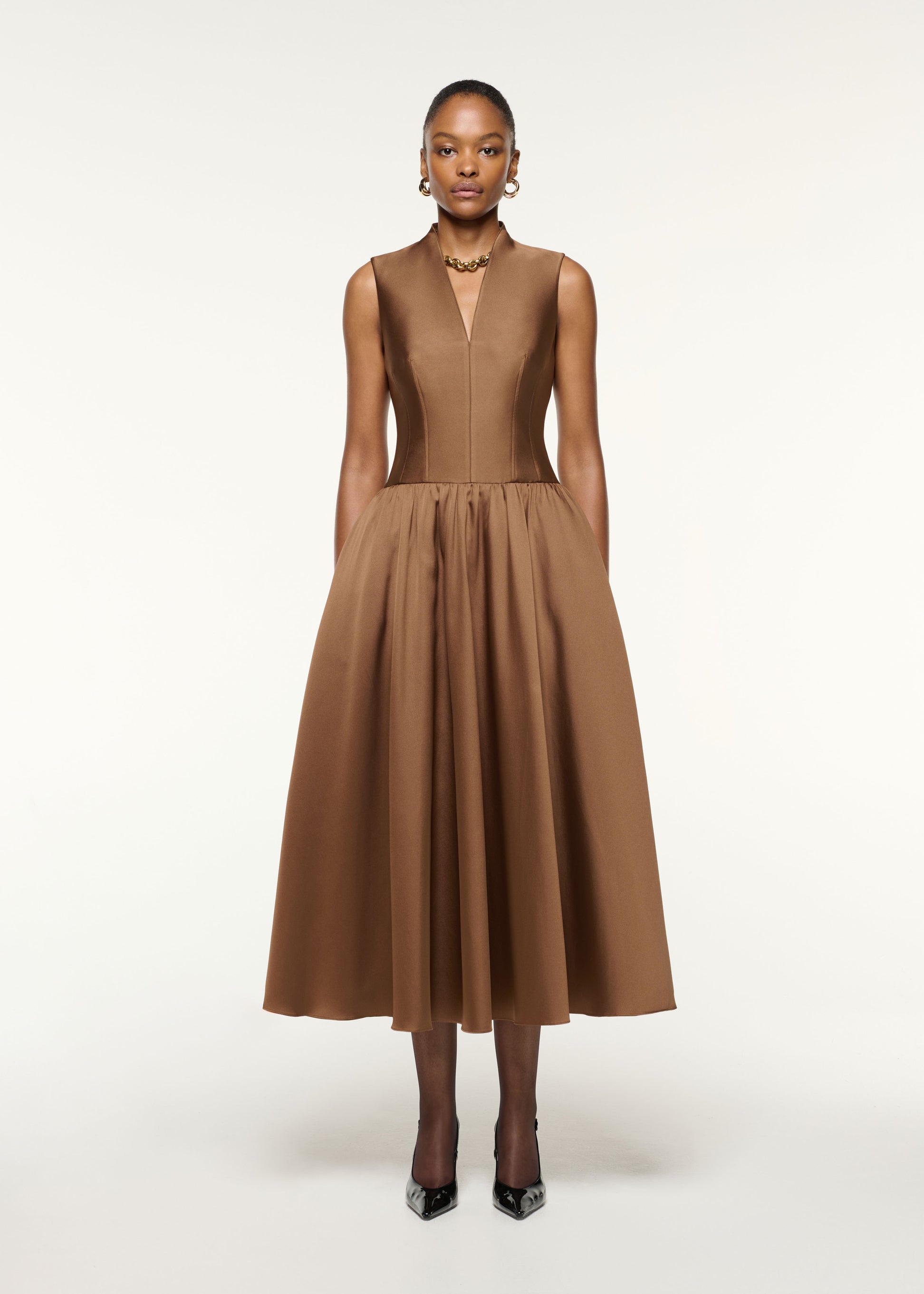 Front view of a model wearing the Dropped Gathered Waist Taffeta Dress in Brown