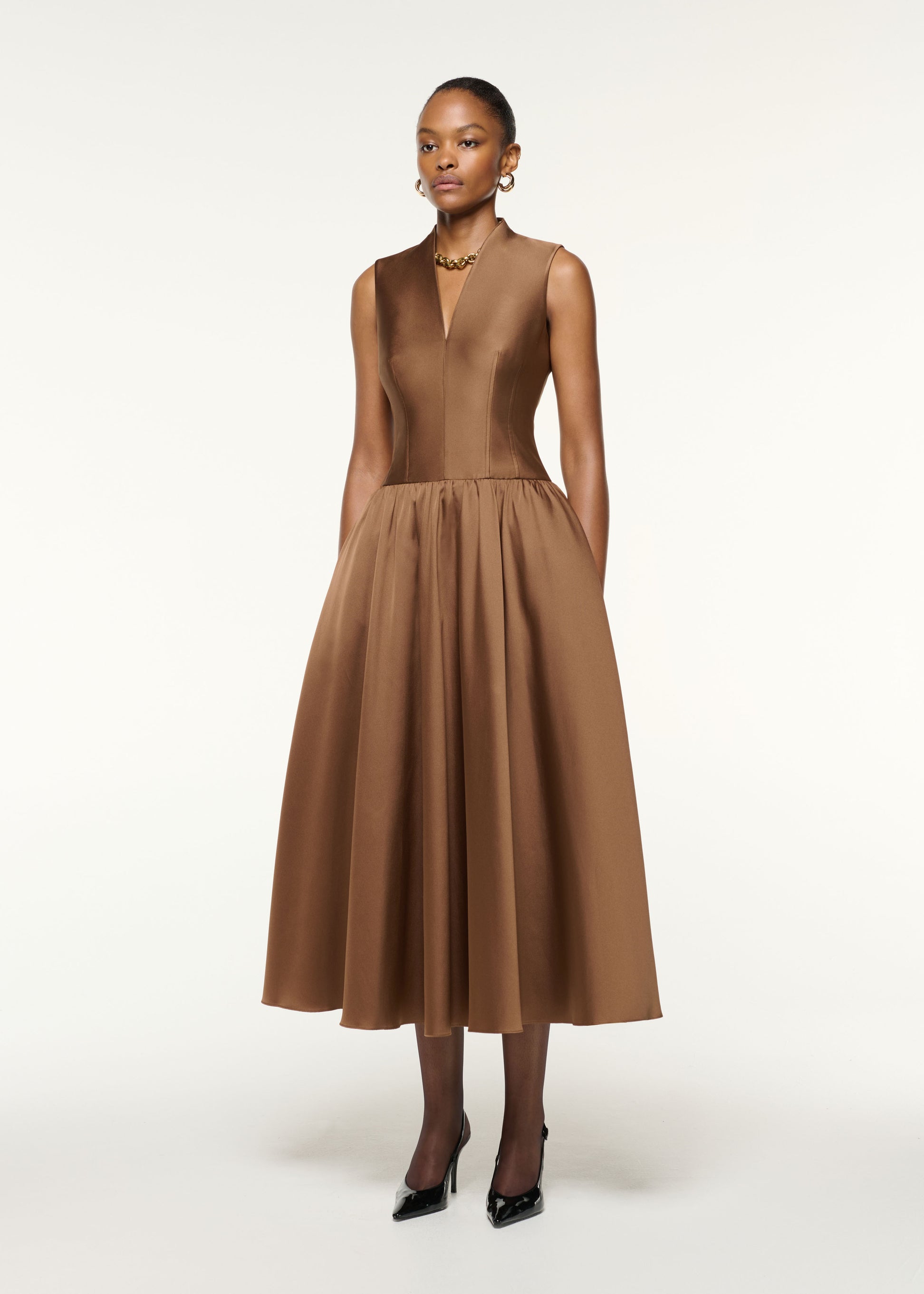 Side view of a model wearing the Dropped Gathered Waist Taffeta Dress in Brown