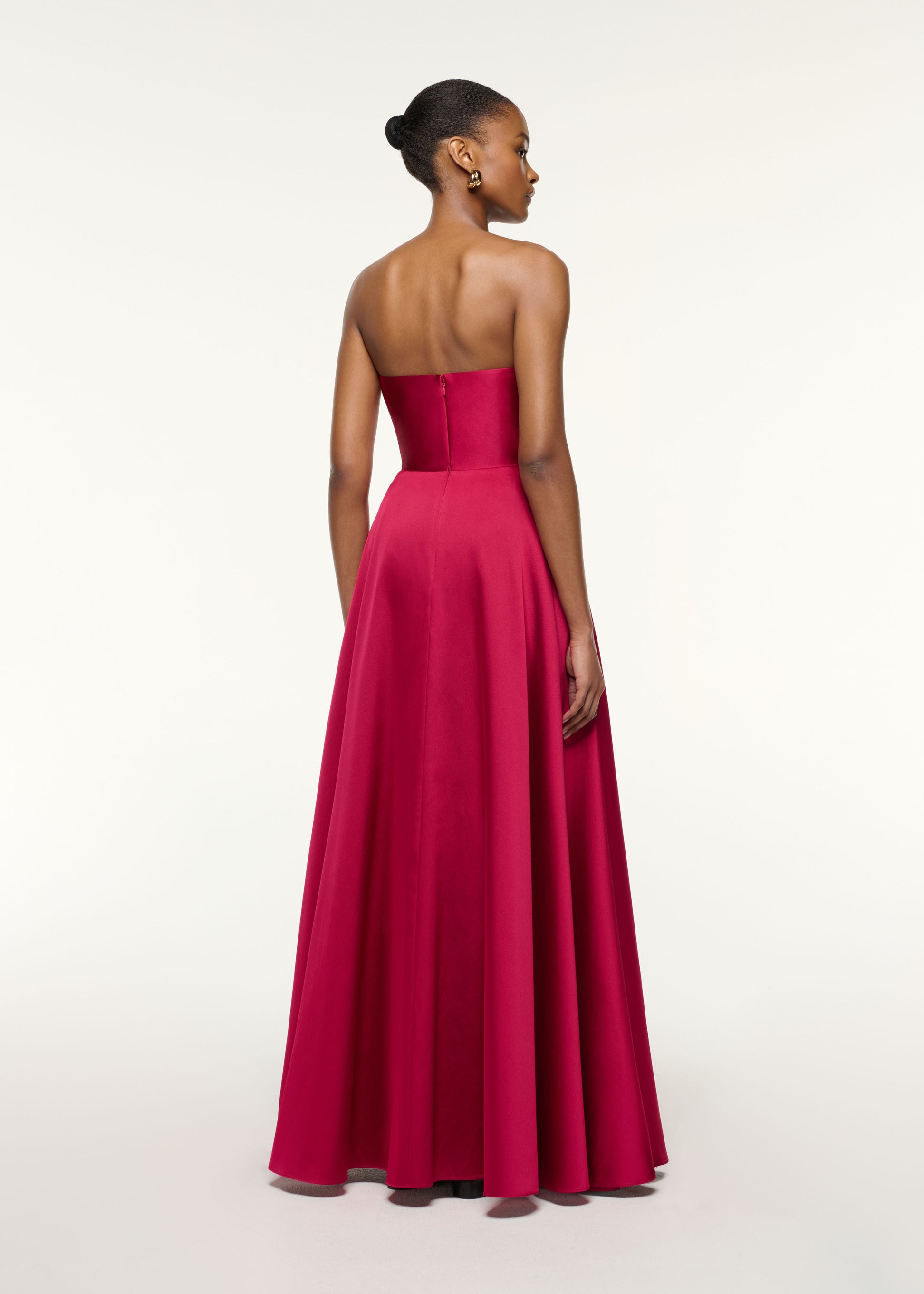 Back view of a model wearing the Pleated Bust Taffeta Evening Gown in Pink