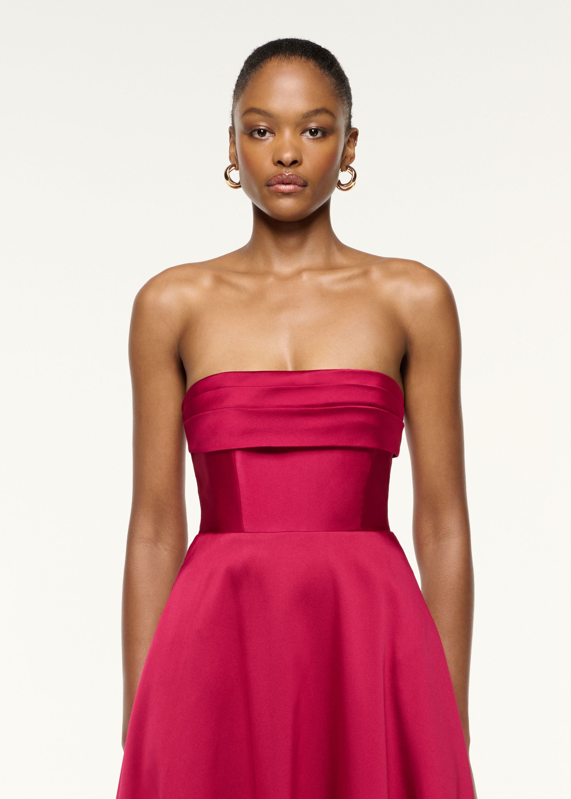 Close up of a model wearing the Pleated Bust Taffeta Evening Gown in Pink